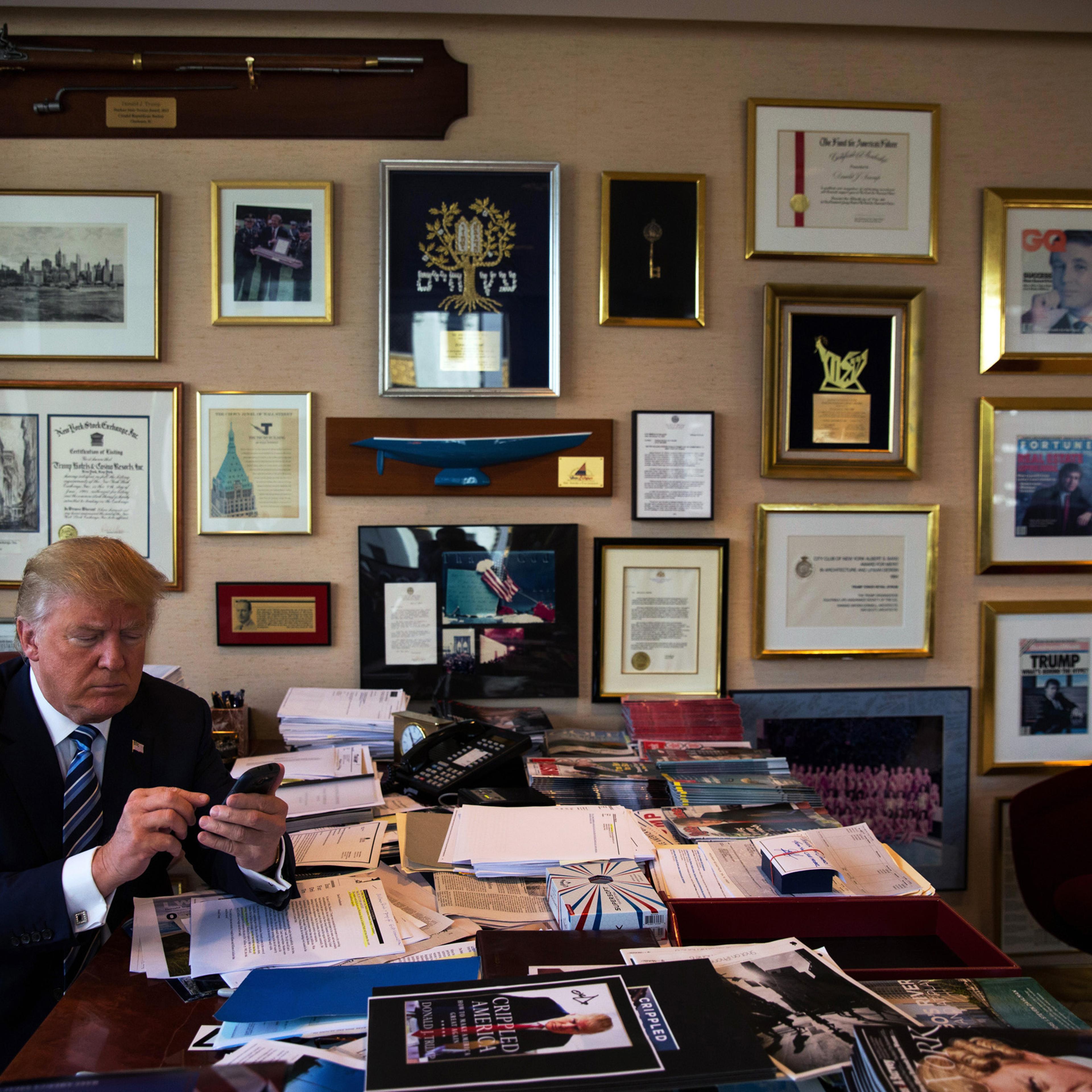 Donald Trump demonstrates how he Tweets using his Samsung phone in his office in the Trump Tower in New York City on Sept. 29, 2015.