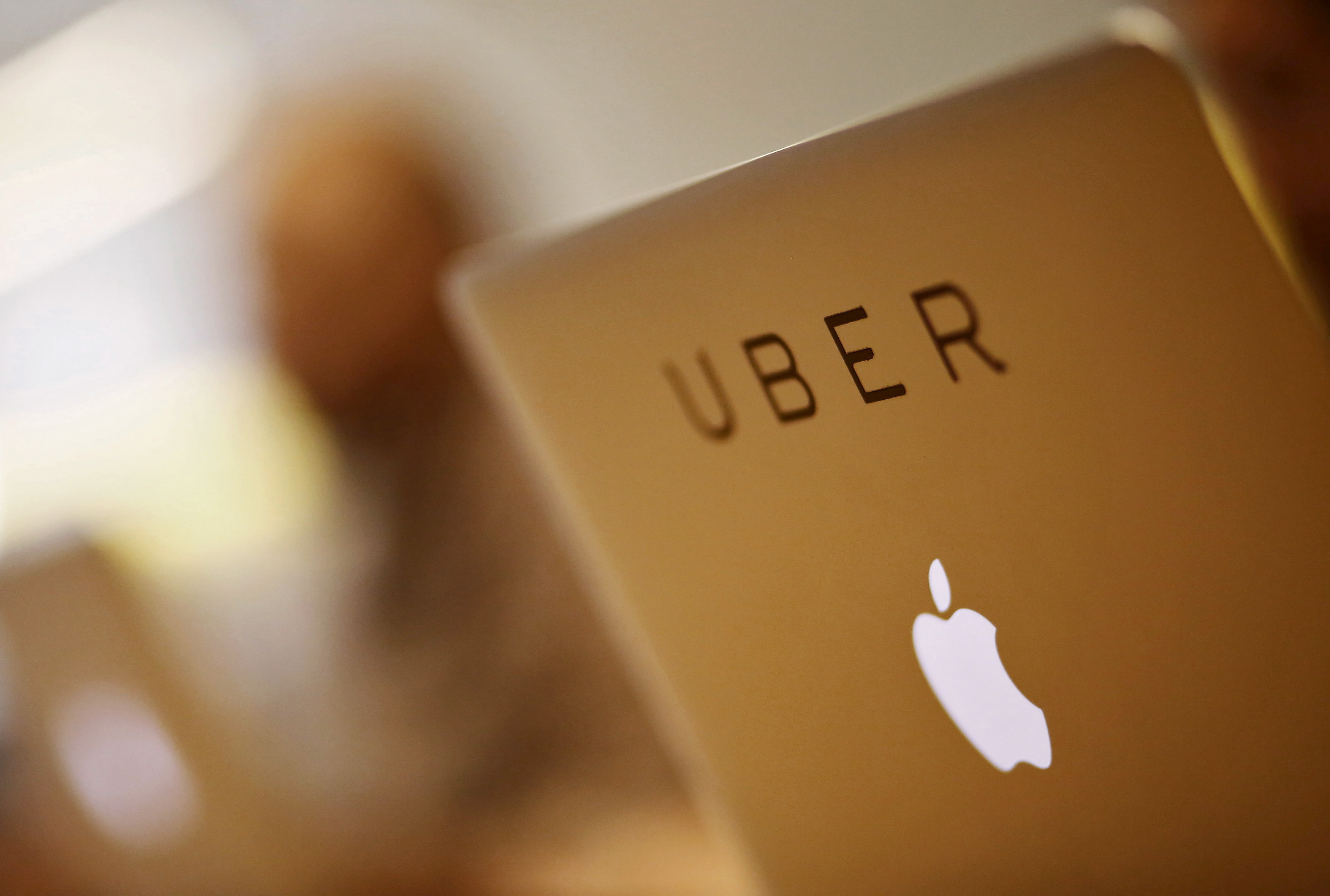 Employee works inside the office of U.S. online cab-hailing company Uber on the outskirts of New Delhi