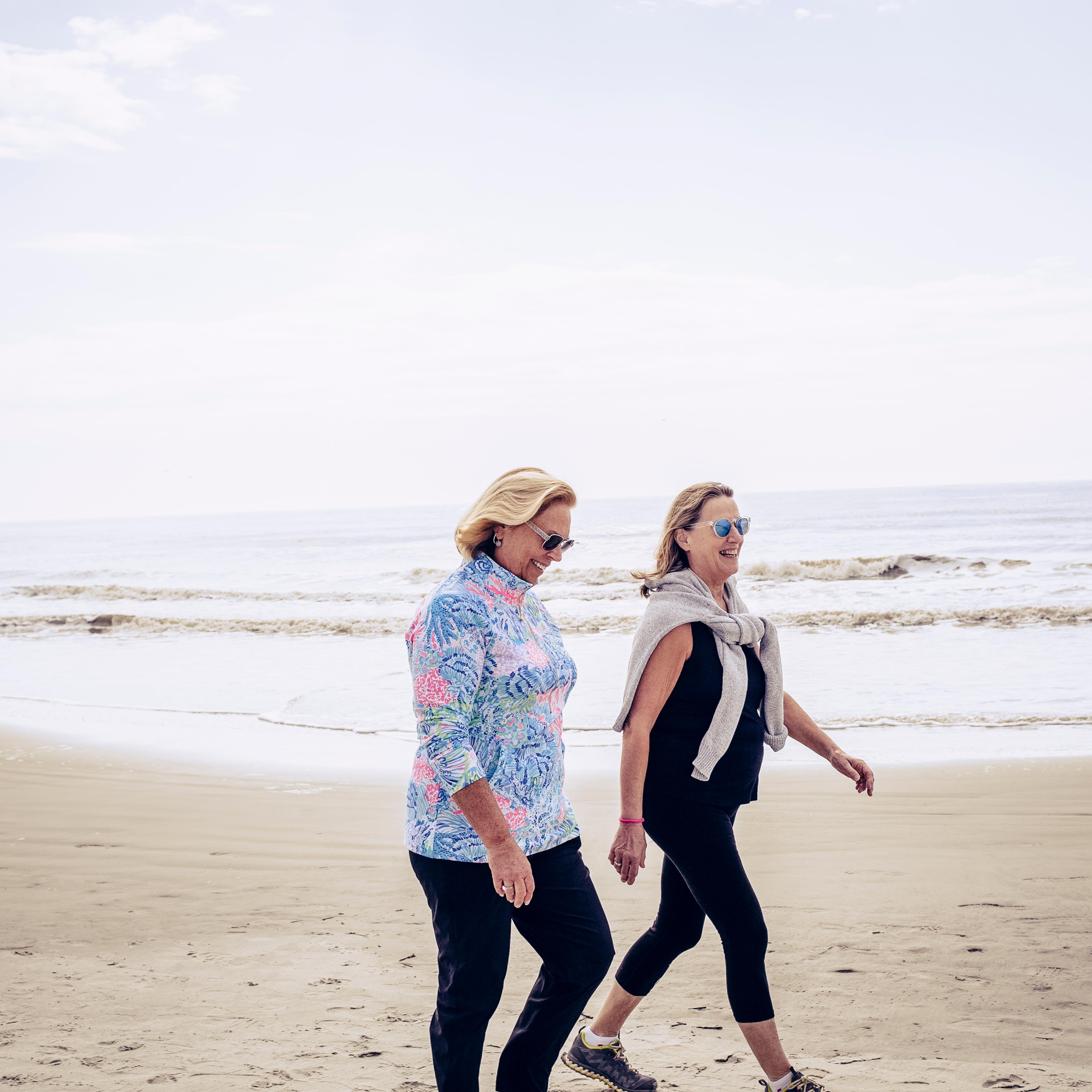 Senior women enjoying walk on beach