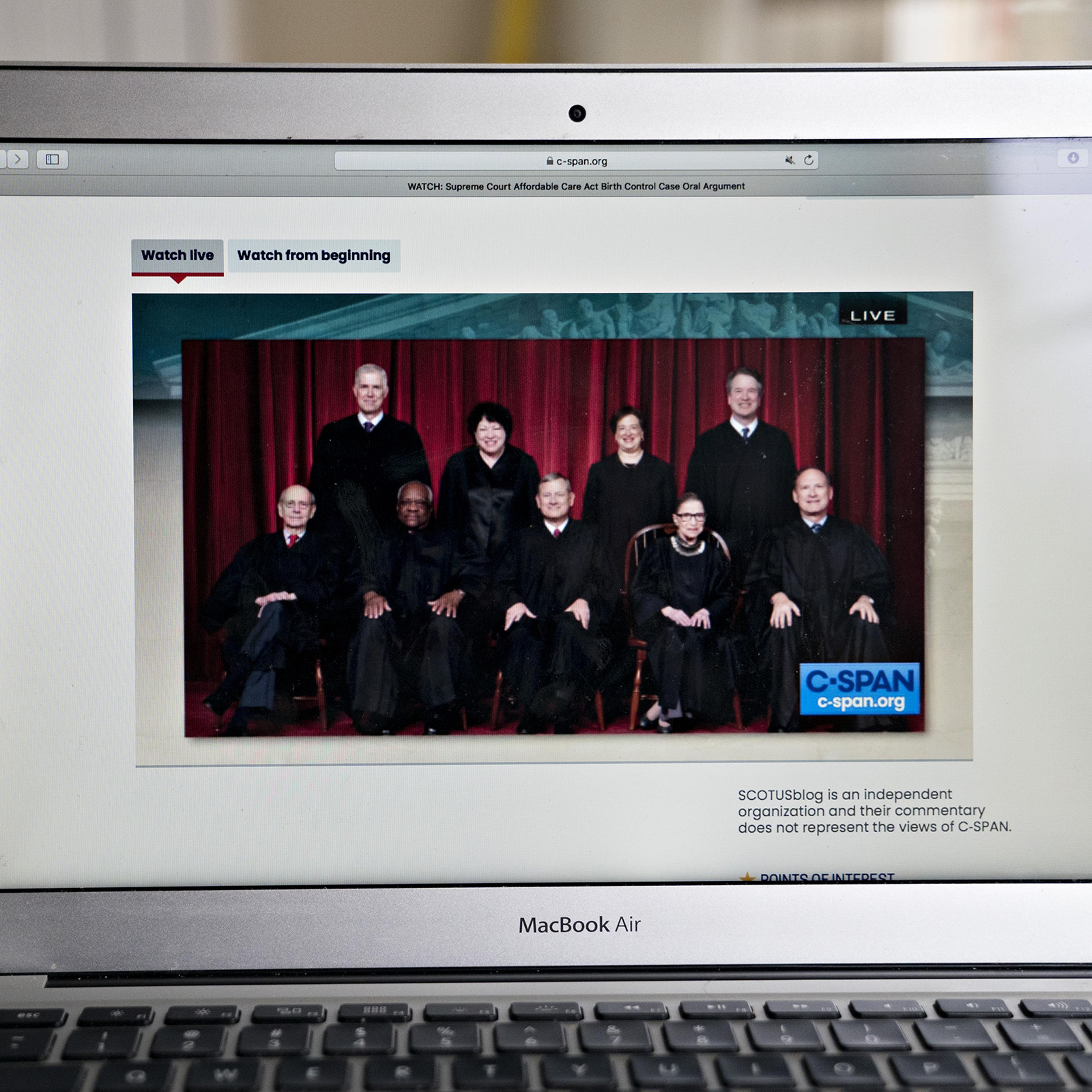 Justices of the U.S. Supreme Court are displayed on a laptop computer during oral arguments before the Supreme Court in Little Sisters of the Poor v. Pennsylvania in an arranged photograph taken in Arlington, Virginia, on May 6
