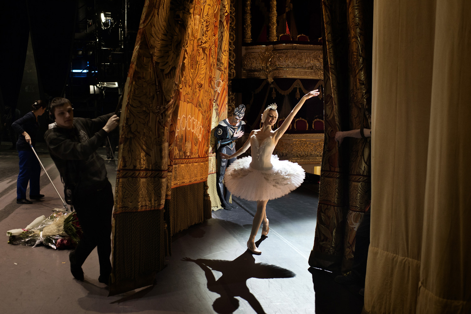 Moscow Russia February 03 2013 Svetlana Zakharova, prima ballerina of the Bolshoi Ballet, comes out for a curtain call with principal dancer Nikolai Tsiskaridze, who bows in the background, after a performance of Swan Lake on the historical stage of the 