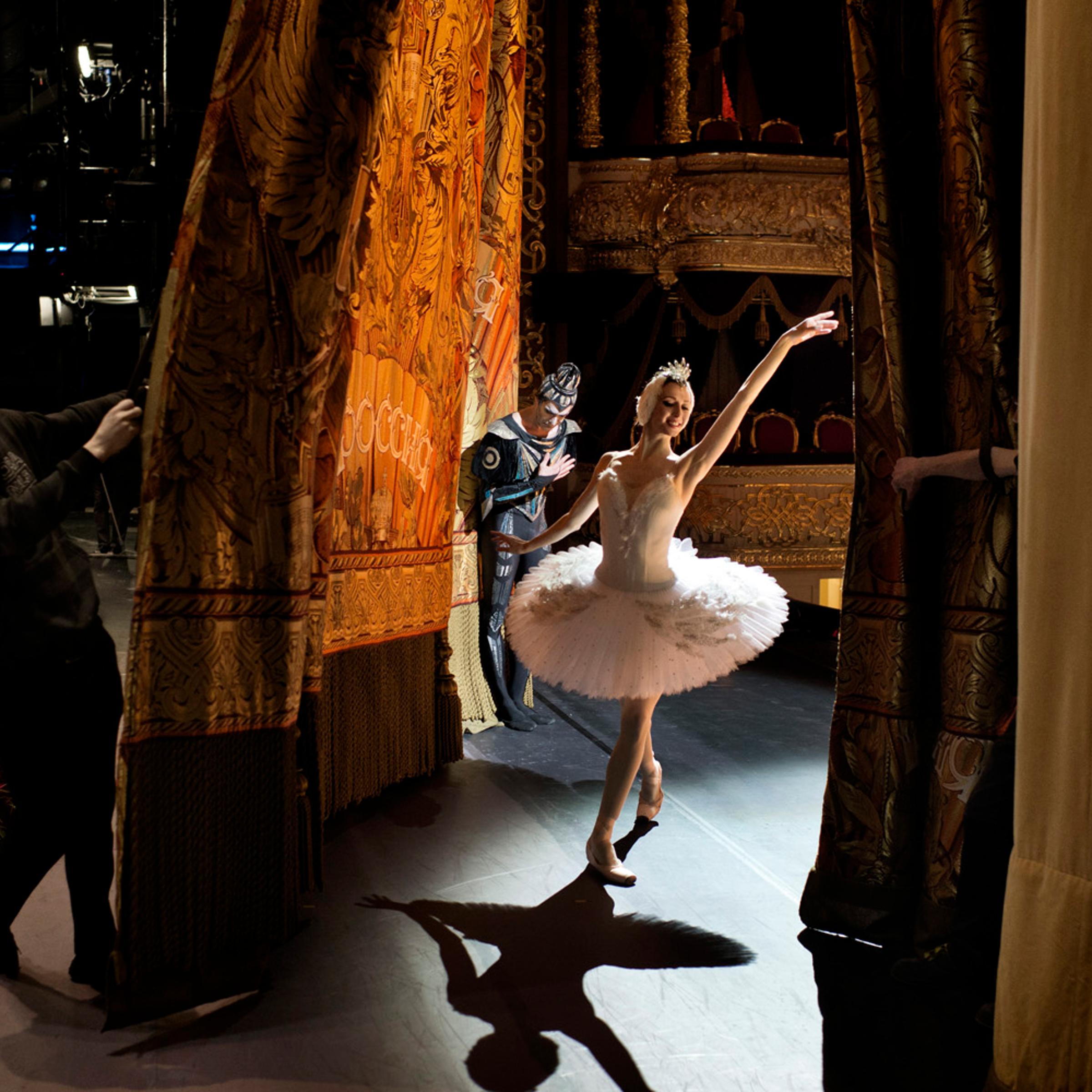 Moscow Russia February 03 2013 Svetlana Zakharova, prima ballerina of the Bolshoi Ballet, comes out for a curtain call with principal dancer Nikolai Tsiskaridze, who bows in the background, after a performance of Swan Lake on the historical stage of the