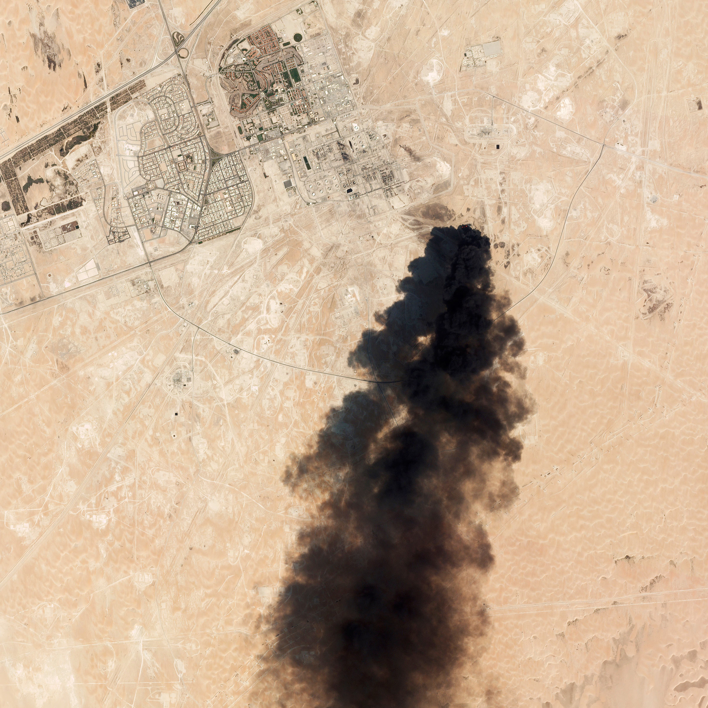A satellite image shows smoke rising from an oil-­processing plant in Buqyaq, Saudi Arabia, on Sept. 14
