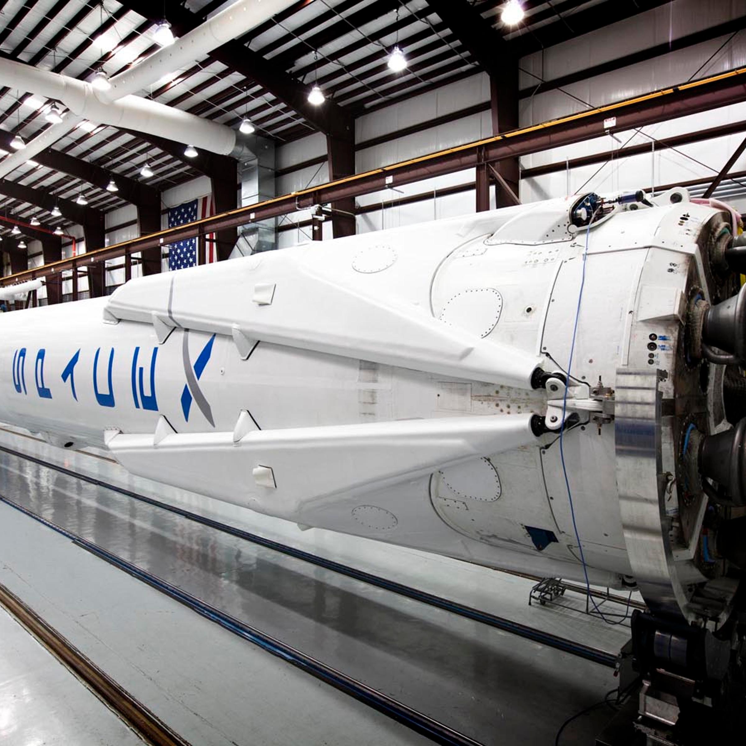 Falcon 9 awaits its upcoming launch in SpaceX's hangar with landing legs attached on March 12, 2014.