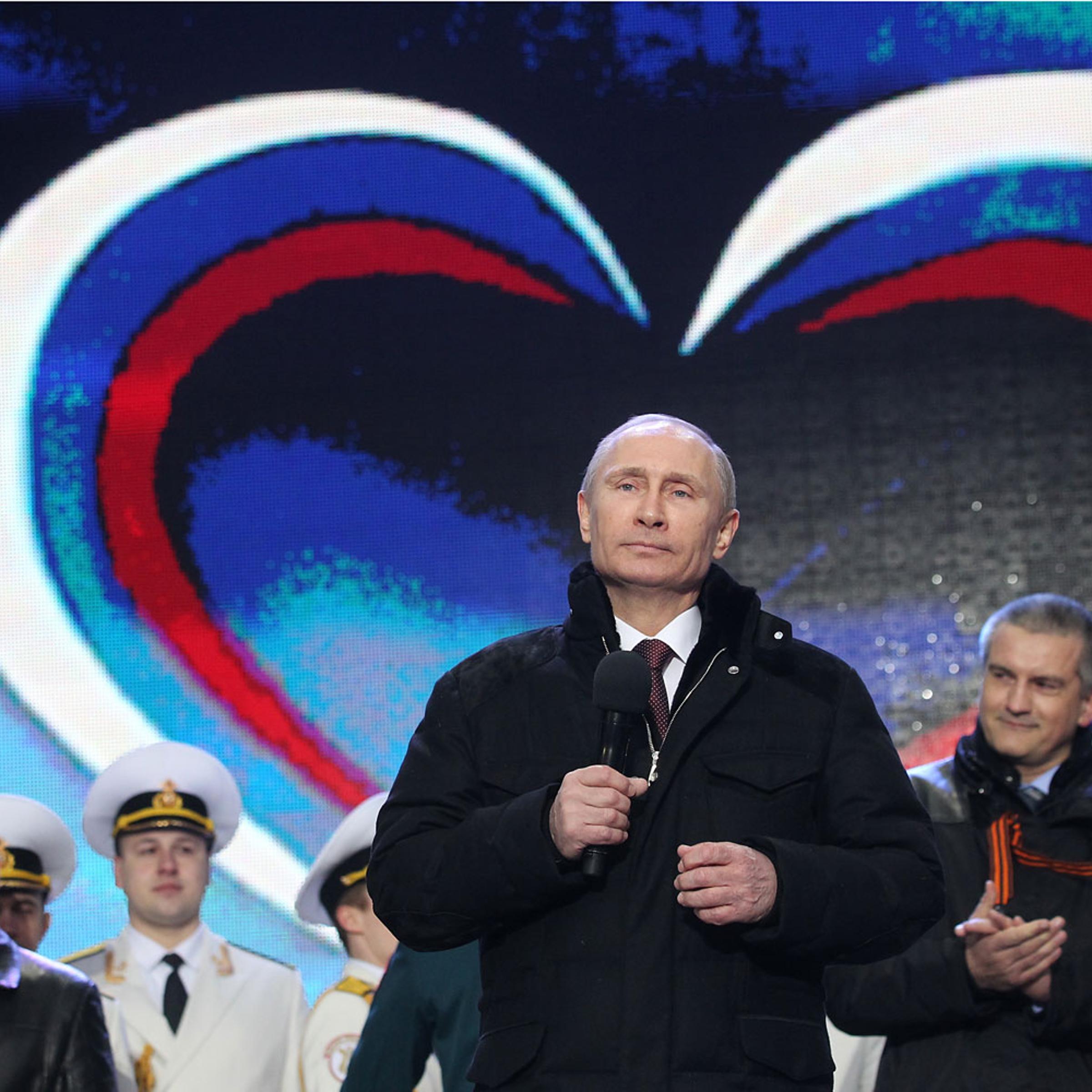 Russian President Vladimir Putin and Crimean Prime Minister Sergei Aksyonov attend a rally at Red Square on March 18, 2014 in Moscow.