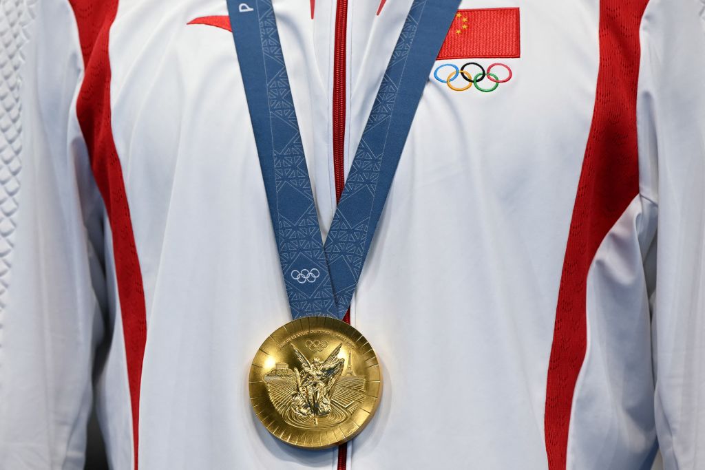 China's gold medalist Pan Zhanle on the podium of the Paris Olympics men's 100m freestyle swimming event at the Paris La Defense Arena in Nanterre, west of Paris, on July 31, 2024.