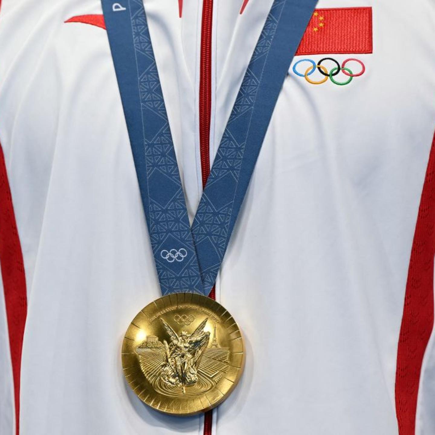 China's gold medalist Pan Zhanle on the podium of the Paris Olympics men's 100m freestyle swimming event at the Paris La Defense Arena in Nanterre, west of Paris, on July 31, 2024.