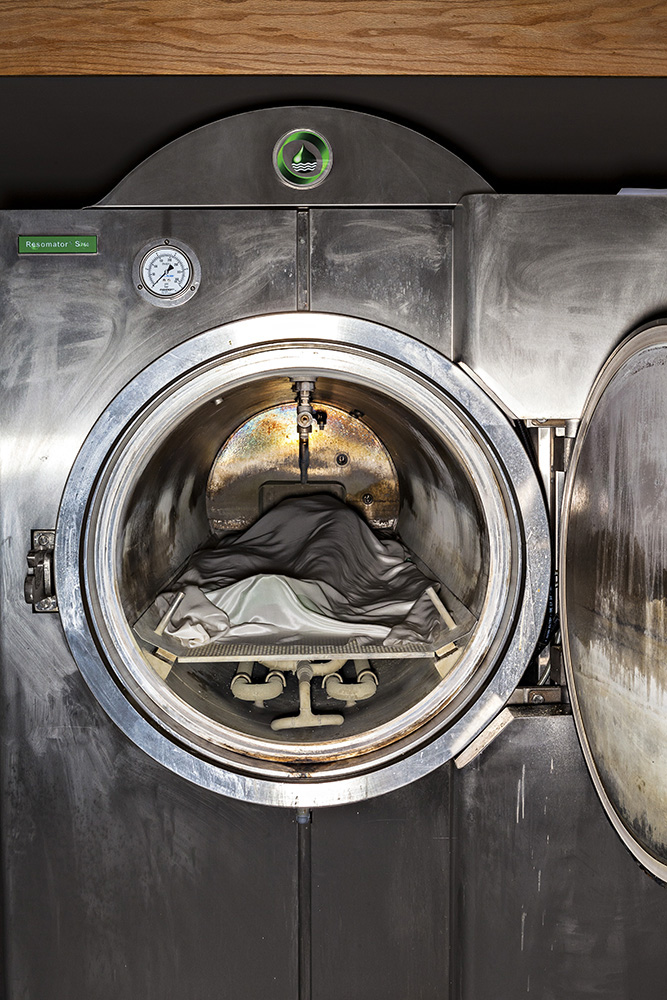 A dead body ready for cremation has just been inserted into an eco-friendly Resomator machine. Instead of flames, this stainless steel chamber owned by Bradshaw Funeral and Cremation Services uses a combination of water, potassium hydroxide and heat to break down bodies into peptides, soaps, salts and sugars.