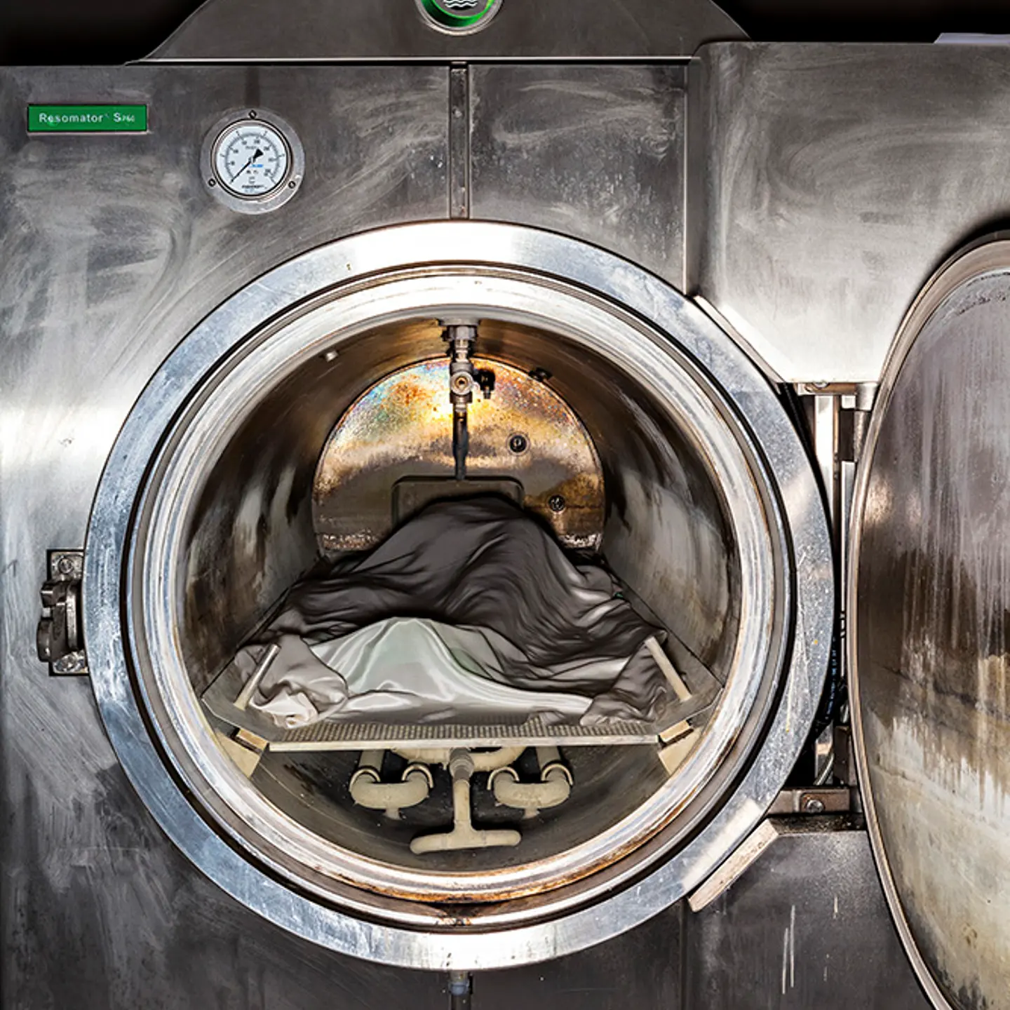 A dead body ready for cremation has just been inserted into an eco-friendly Resomator machine. Instead of flames, this stainless steel chamber owned by Bradshaw Funeral and Cremation Services uses a combination of water, potassium hydroxide and heat to break down bodies into peptides, soaps, salts and sugars.
