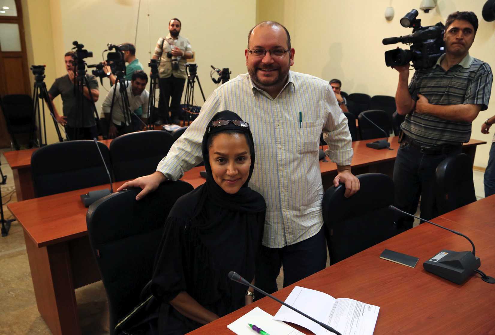 Washington <i>Post</i> Iranian-American journalist Jason Rezaian, right, and his Iranian wife Yeganeh Salehi, who works for the the <i>National</i>, an UAE newspaper, during a Foreign Ministry weekly press conference in Tehran on Sept. 10, 2013