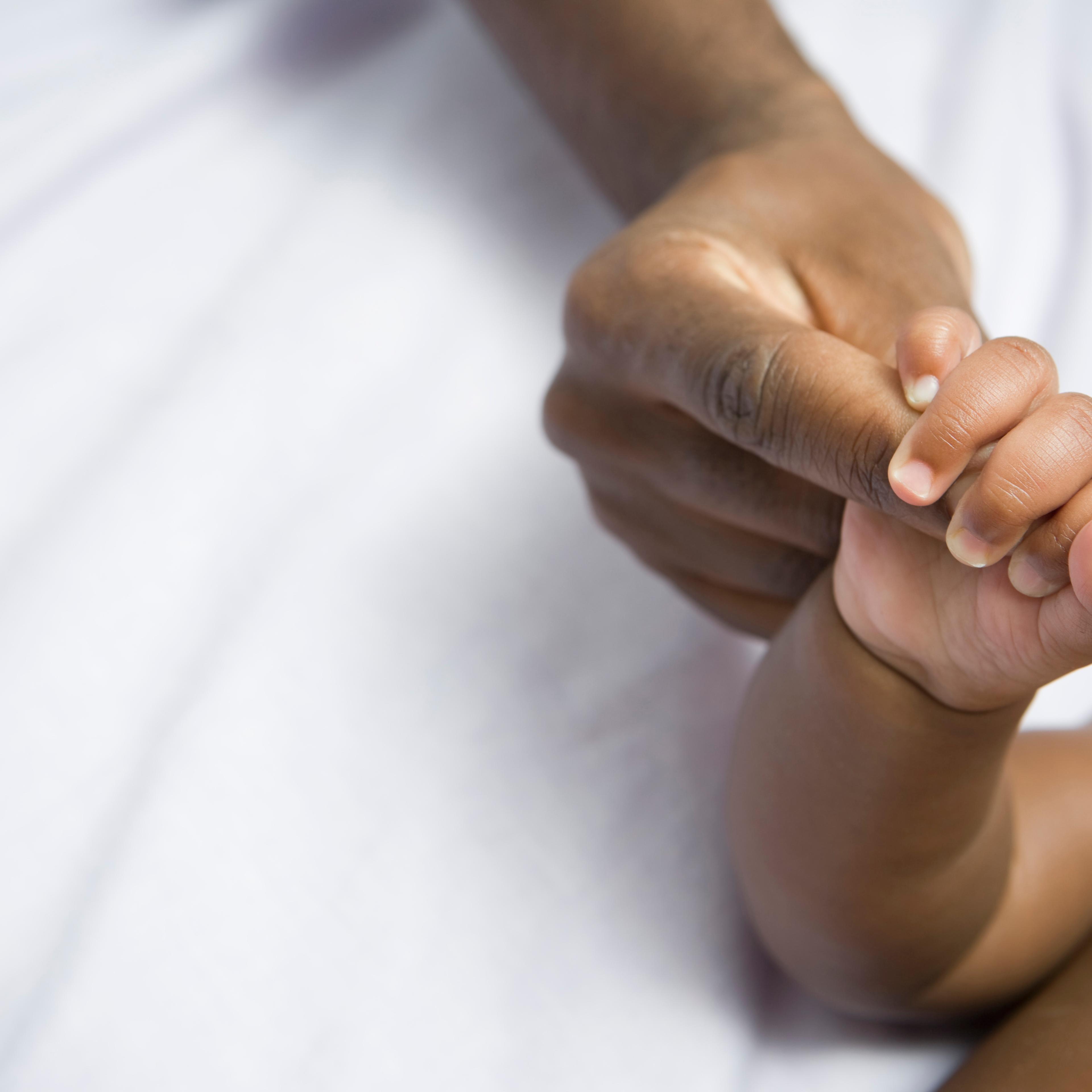 African American Baby and Mom holding hands