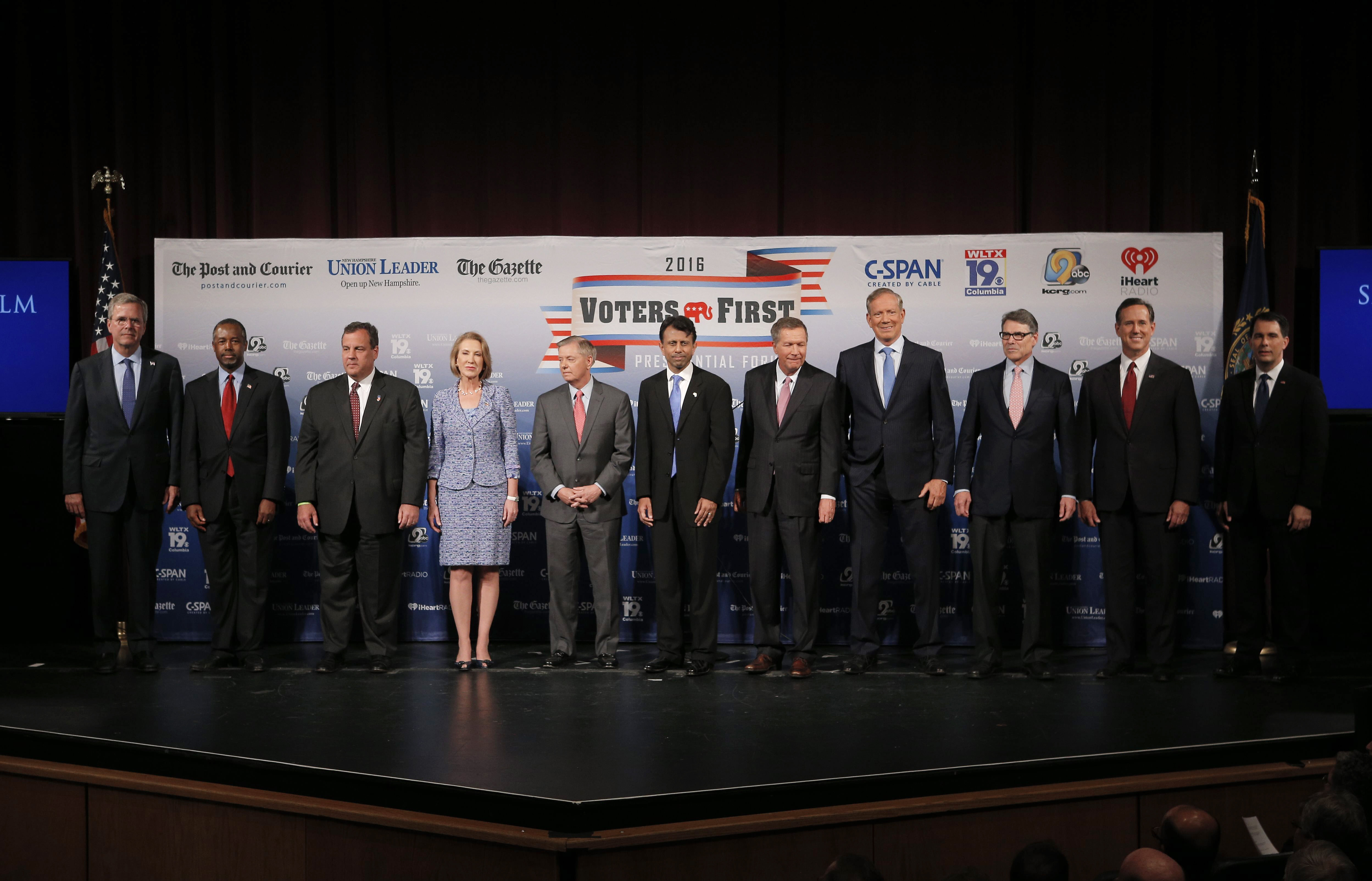 Eleven of the declared 2016 Republican U.S. presidential candidates pose together on stage before the start of the the Voters First Presidential Forum in Manchester