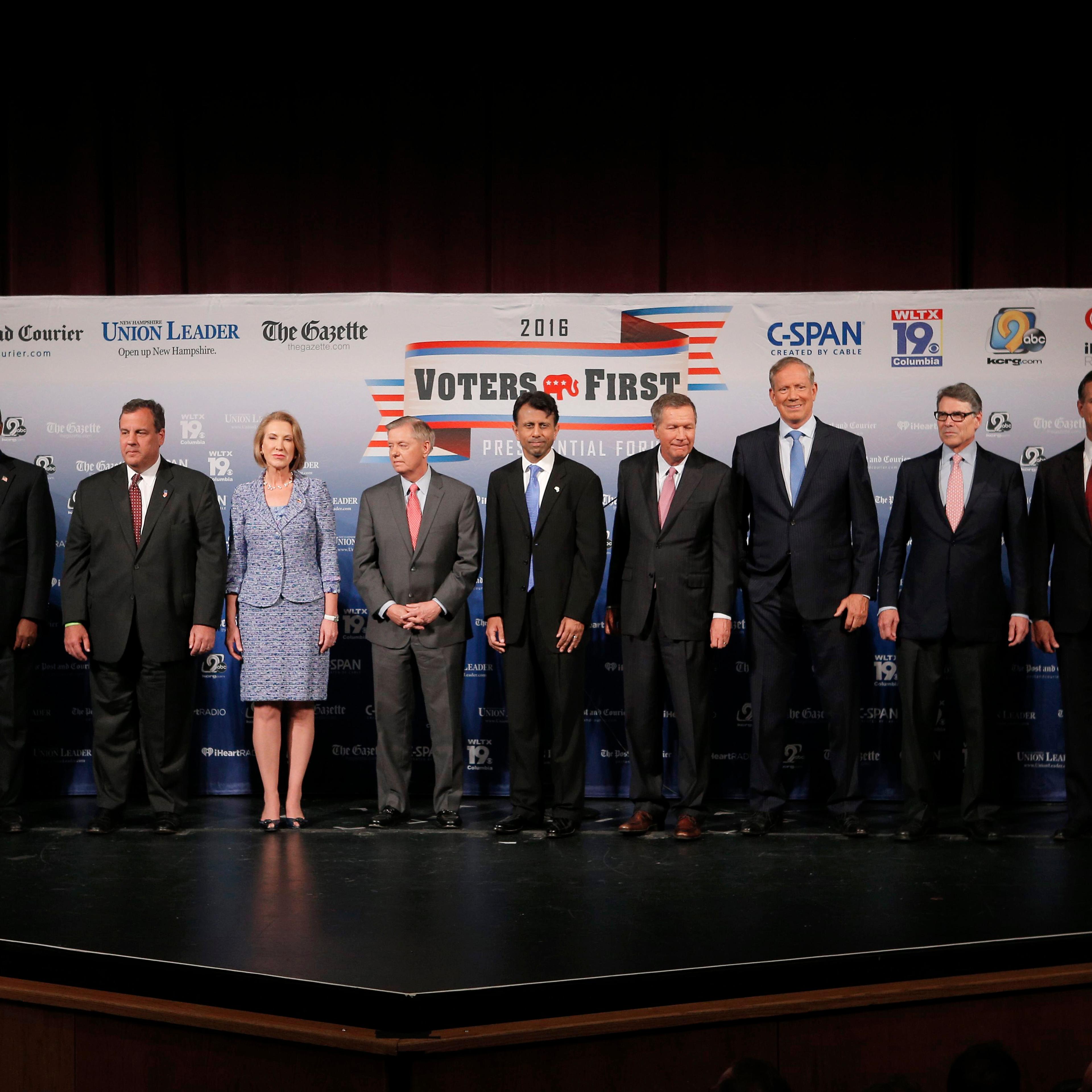 Eleven of the declared 2016 Republican U.S. presidential candidates pose together on stage before the start of the the Voters First Presidential Forum in Manchester