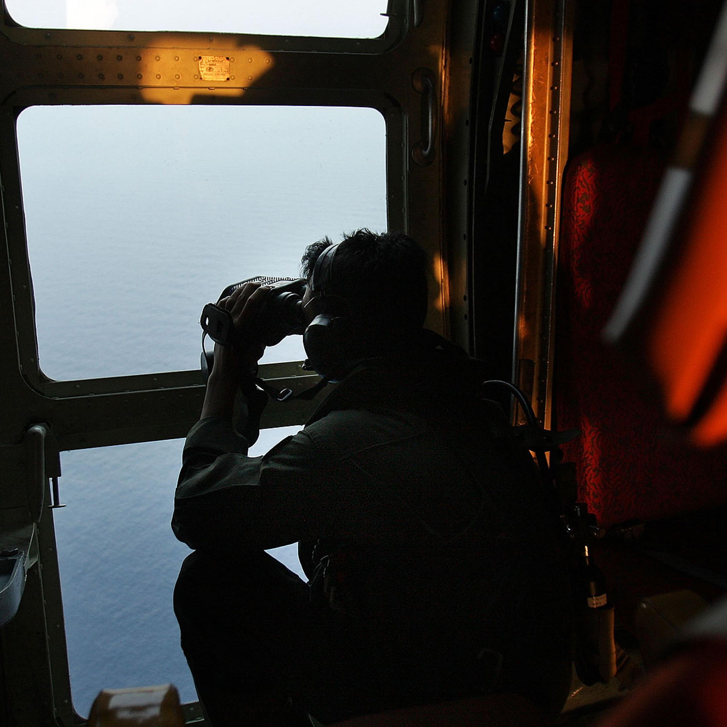 Malaysian Air Forces search the water for signs of debris from the Malaysian airliner during a search and rescue mission flight on March 13, 2014 in Kuala Lumpur, Malaysia