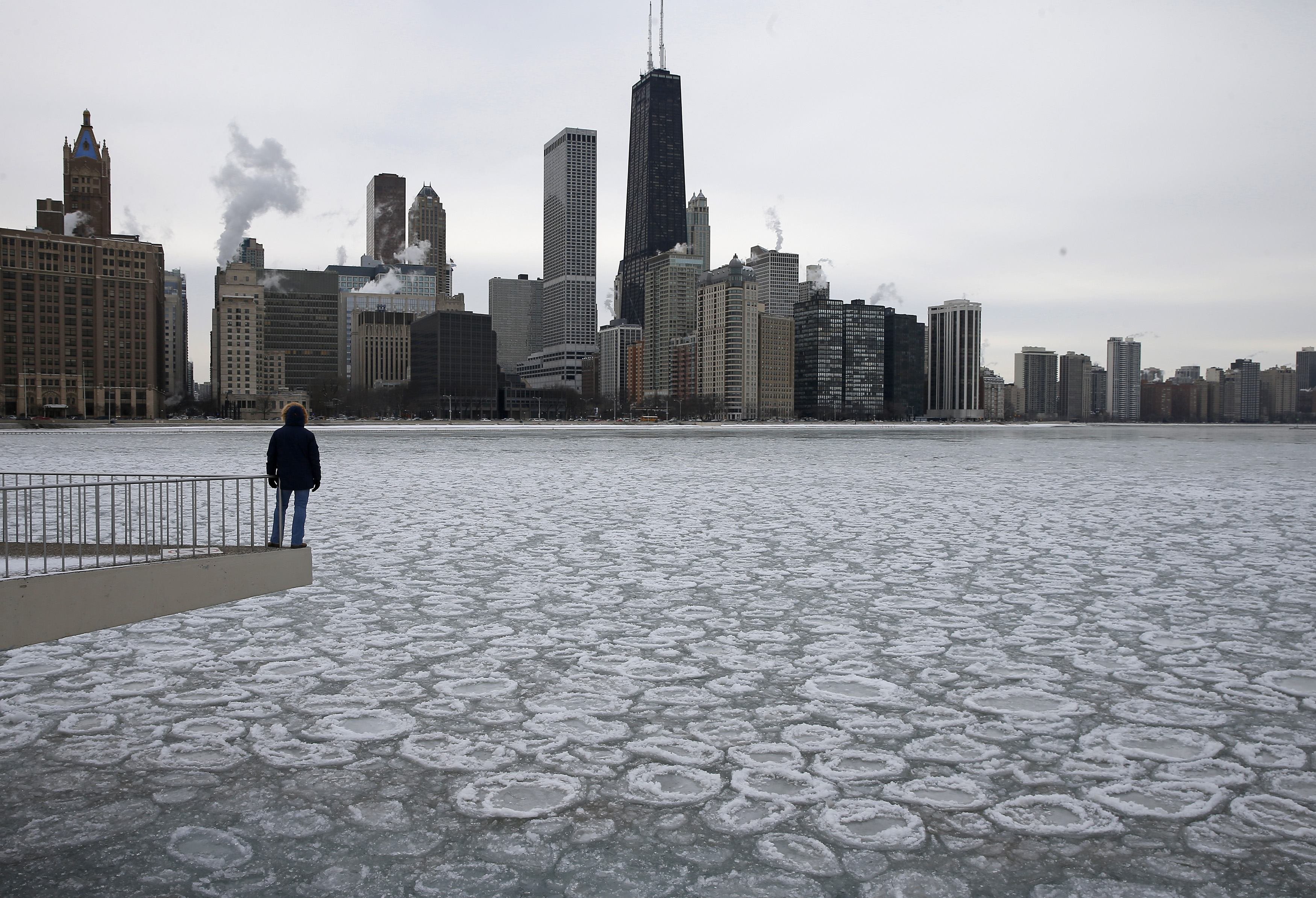 Charles Martinez looks over the partially frozen Lake Michigan and the Chicago skyline on Jan. 5, 2015.