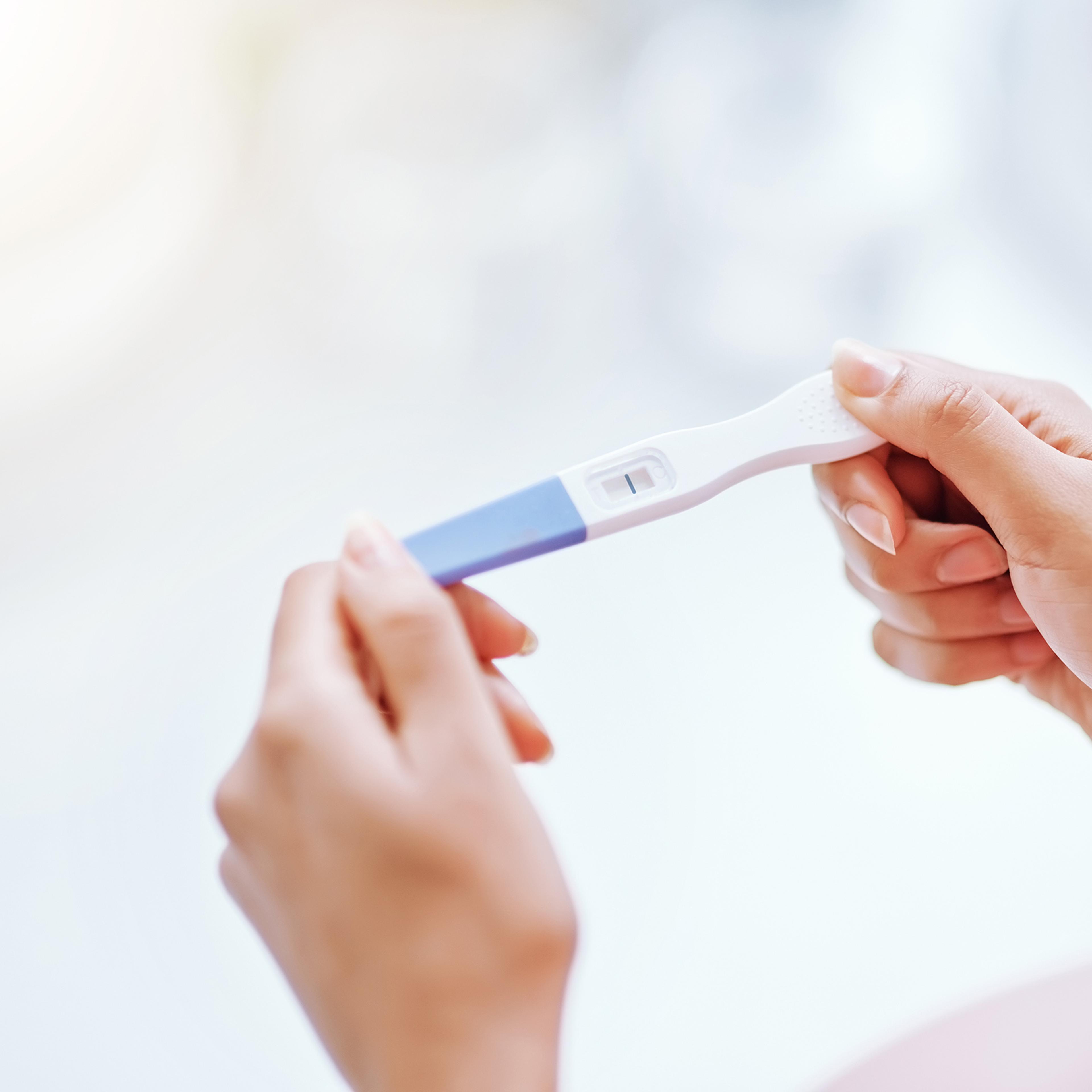 A young woman taking a pregnancy test