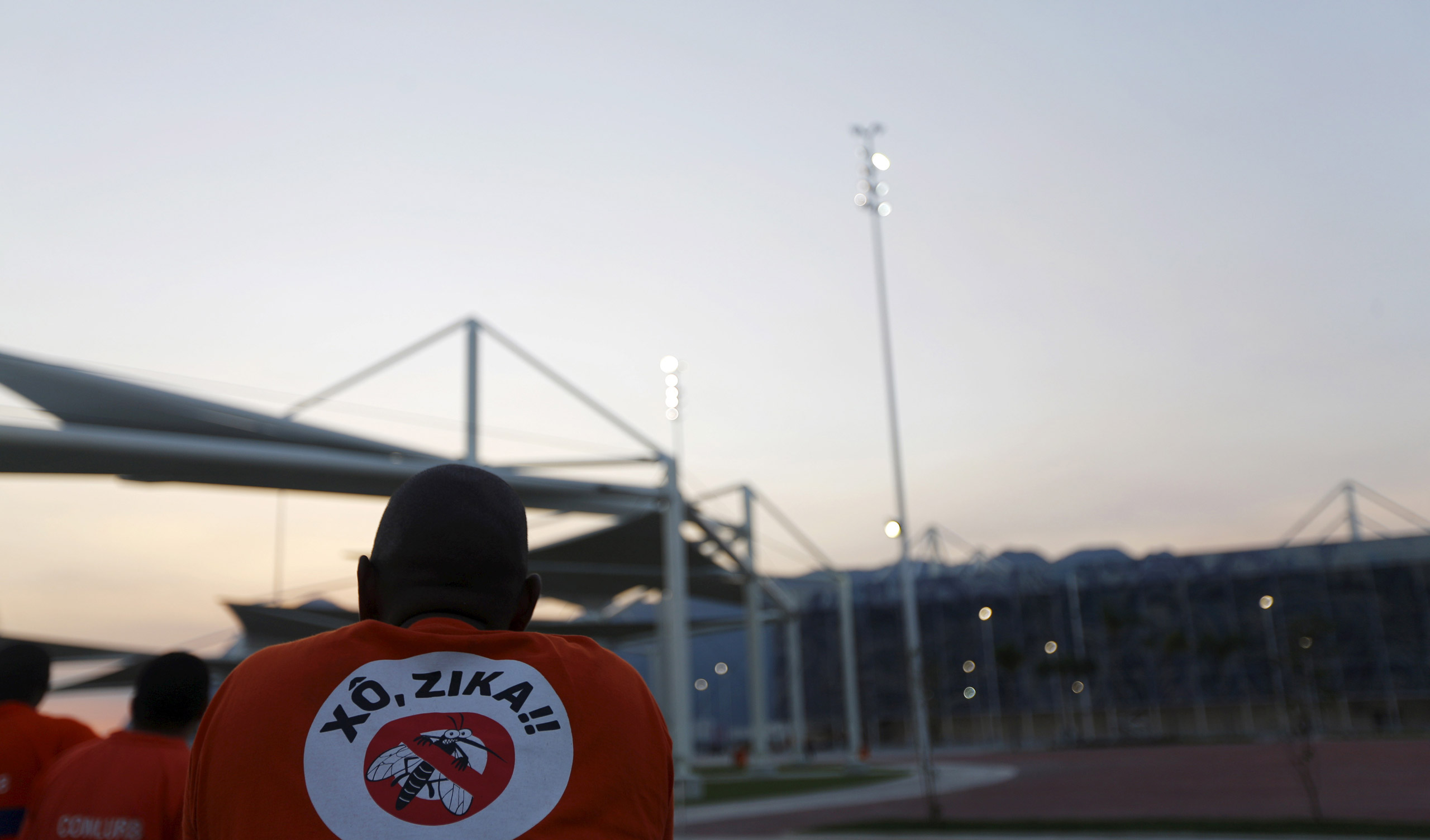 A worker from a public cleaning company wears a T-shirt that reads "Out Zika" is pictured before the inauguration ceremony of the common areas and the Live Site at the 2016 Rio Olympics park in Rio de Janeiro, Brazil, April 11, 2016. REUTERS/Ricardo Mora