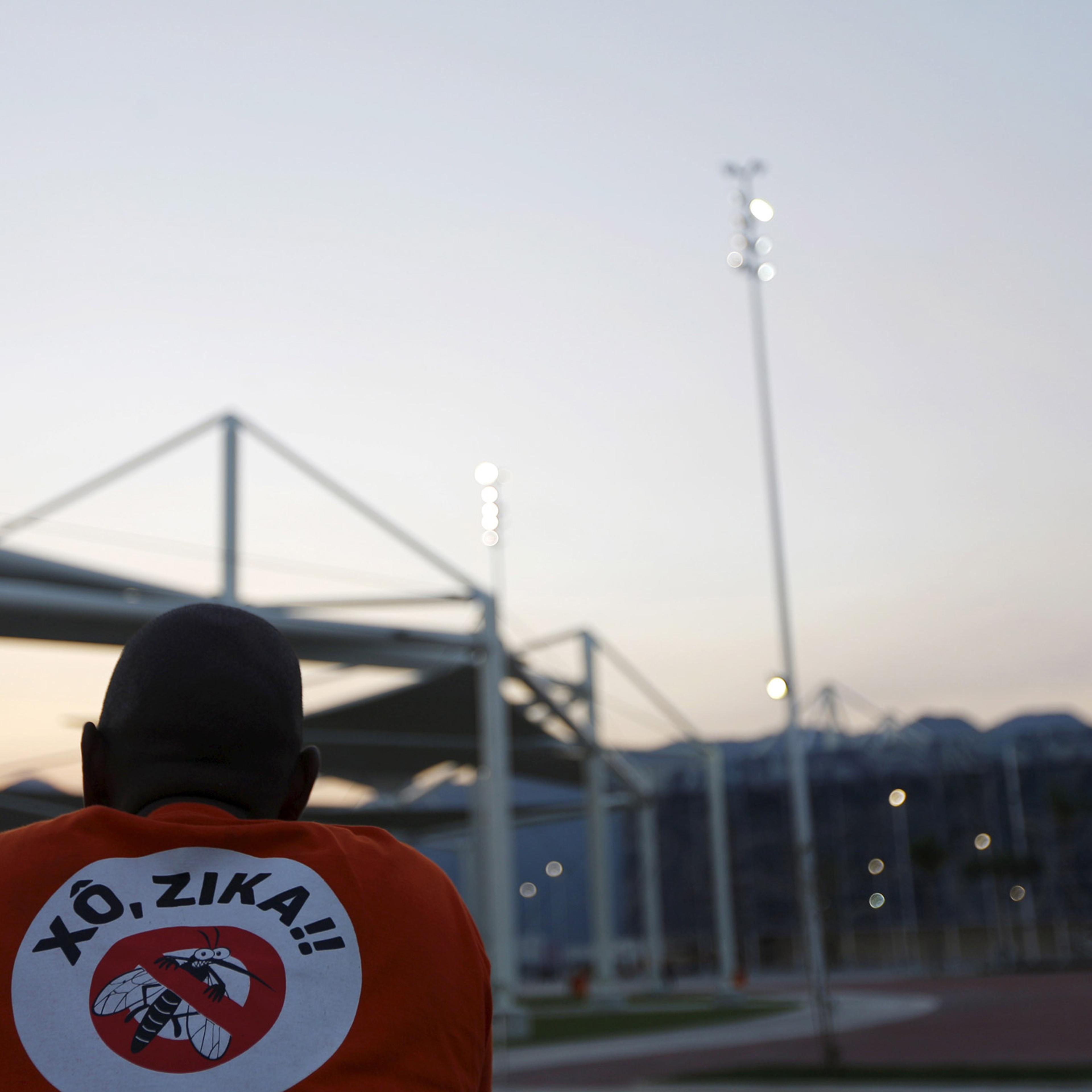 A worker from a public cleaning company wears a T-shirt that reads "Out Zika" is pictured before the inauguration ceremony of the common areas and the Live Site at the 2016 Rio Olympics park in Rio de Janeiro, Brazil, April 11, 2016. REUTERS/Ricardo Mora