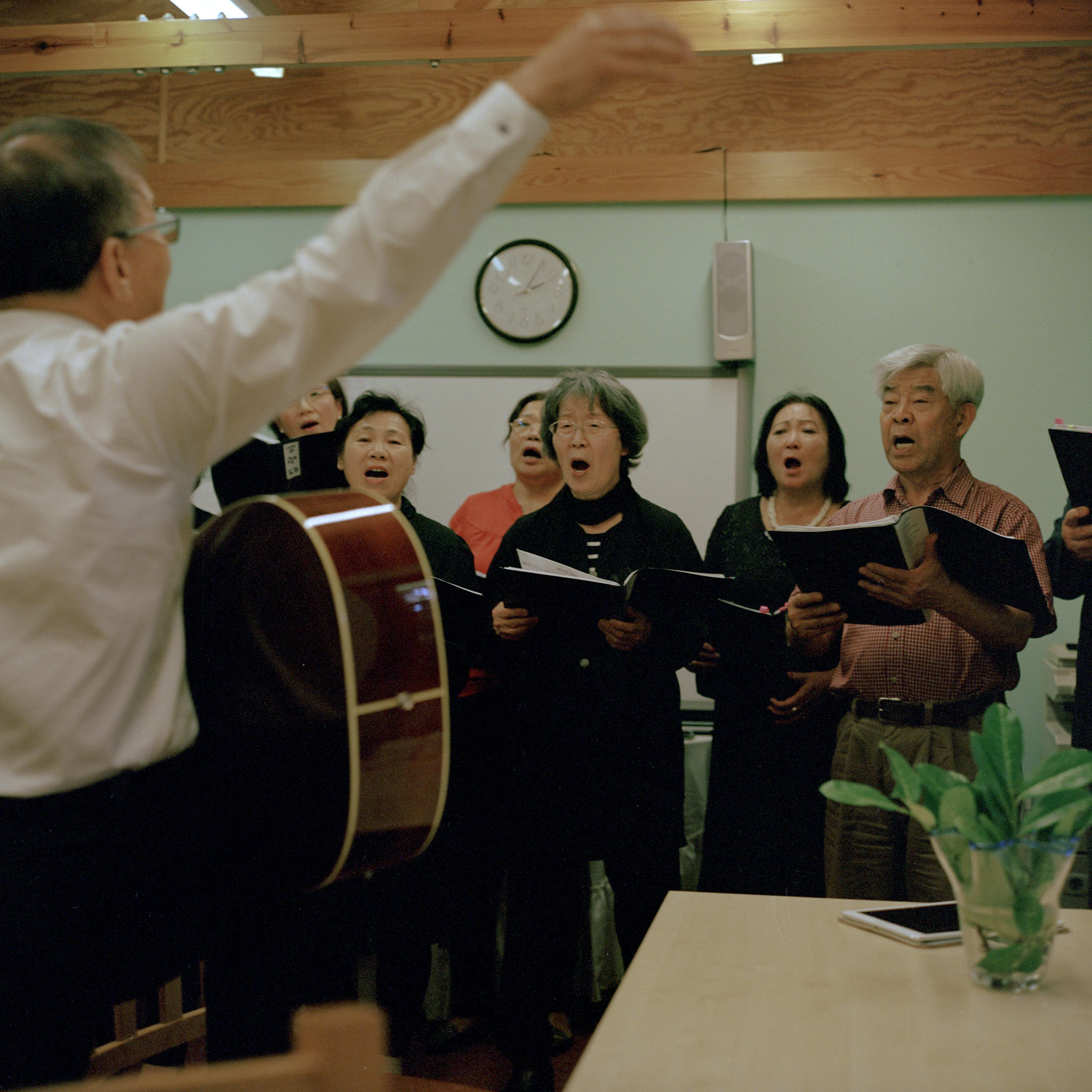 A group of South Koreans, North Koreans, and Korean Chinese sing together at the Korean Senior Citizens centre, New Malden, on Sept. 15.