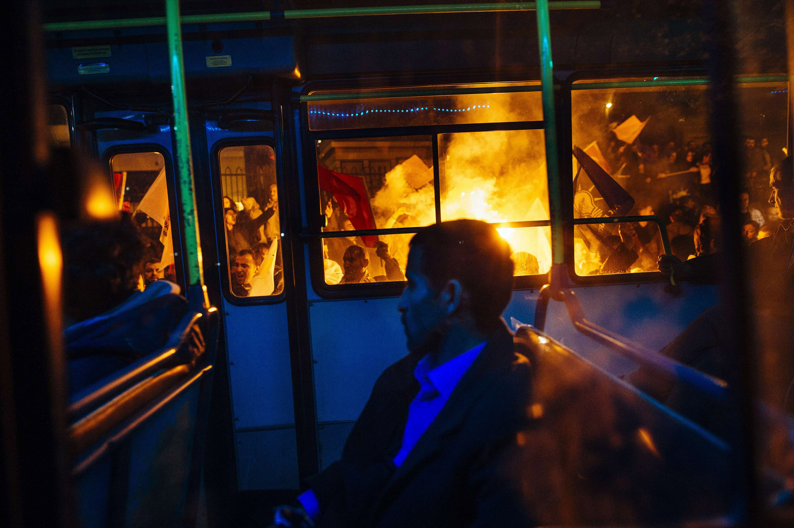 A bus drives past supporters of Turkey's Justice and Development Party (AKP) as they celebrate in Istanbul after the first results in the country's general election on November 1, 2015. Turkey's long-dominant Justice and Development Party (AKP) scored a 