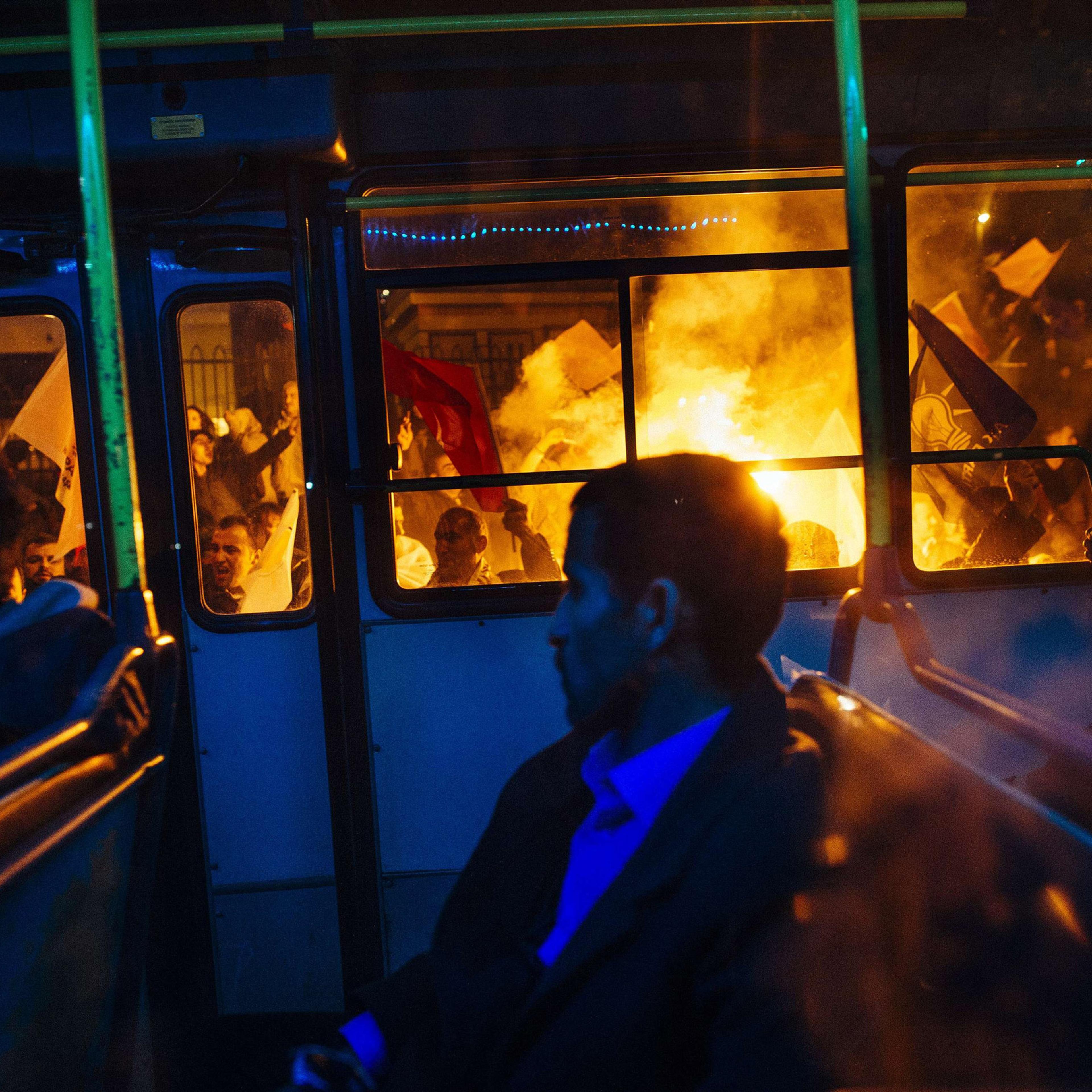 A bus drives past supporters of Turkey's Justice and Development Party (AKP) as they celebrate in Istanbul after the first results in the country's general election on November 1, 2015. Turkey's long-dominant Justice and Development Party (AKP) scored a