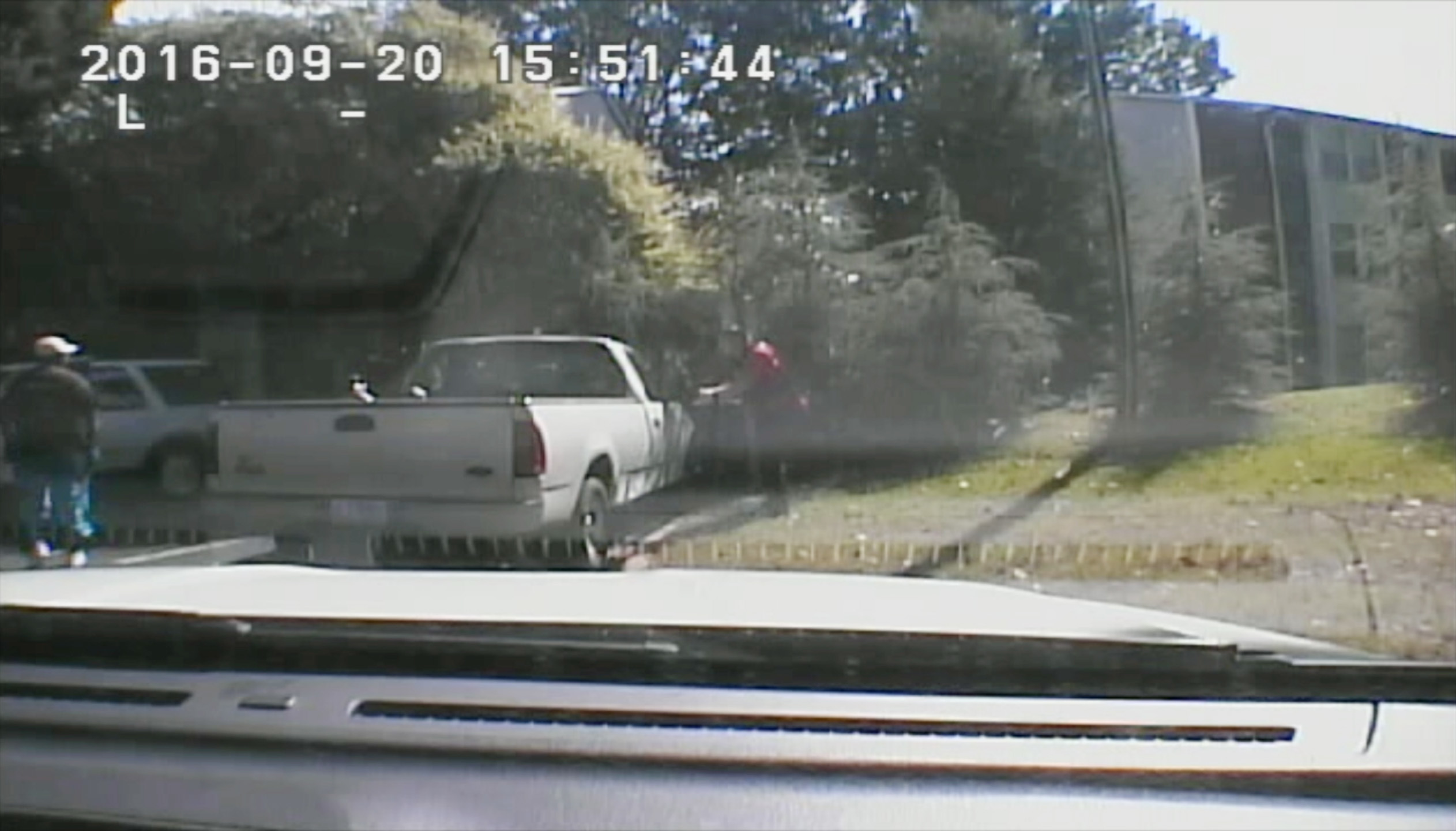 This image made from video provided by the Charlotte-Mecklenburg Police Department on Sept. 24, 2016 shows Keith Scott, left, moments before he was fatally shot by police in Charlotte, N.C., on Sept. 20, 2016.
