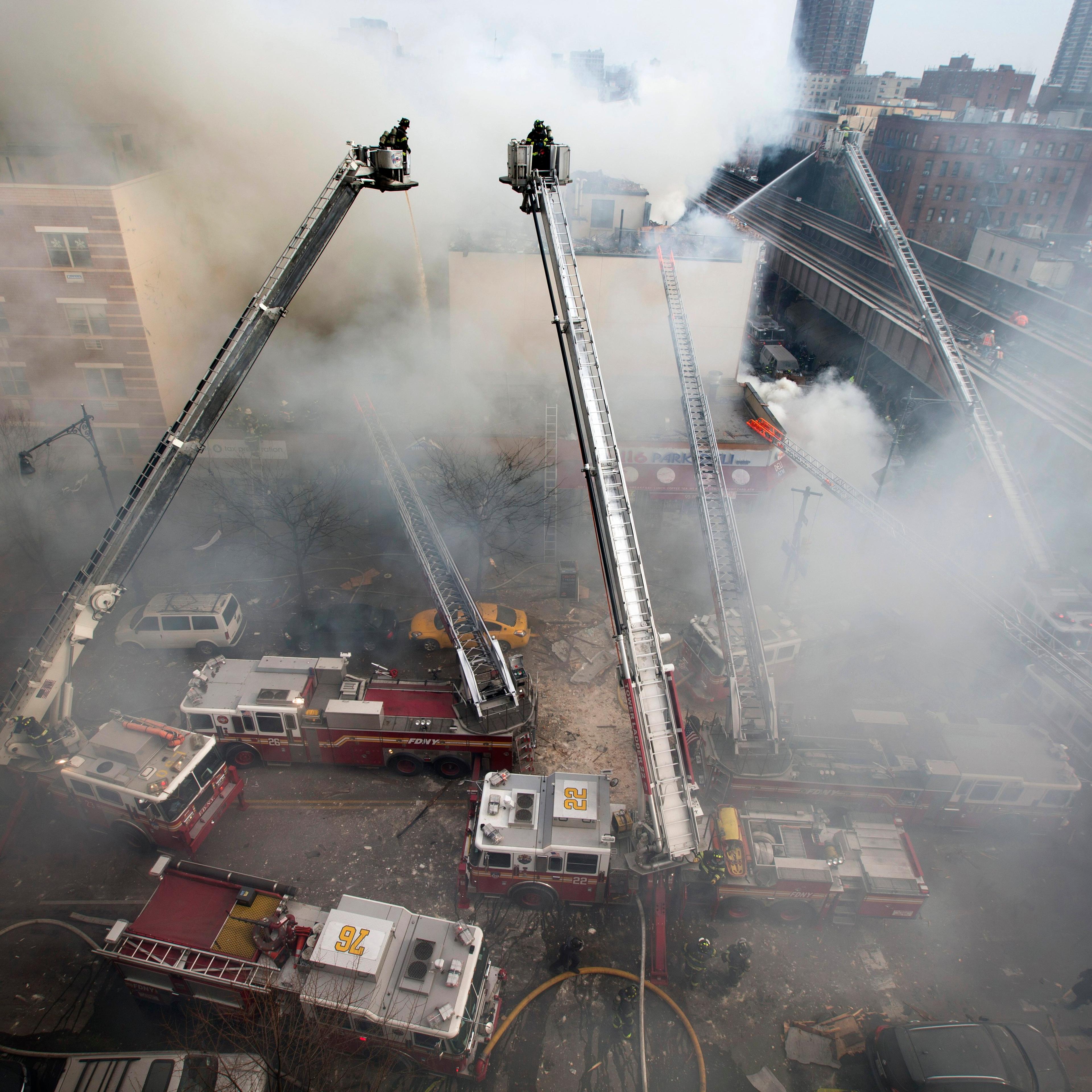 Firefighters respond to an explosion that leveled two apartment buildings in East Harlem.