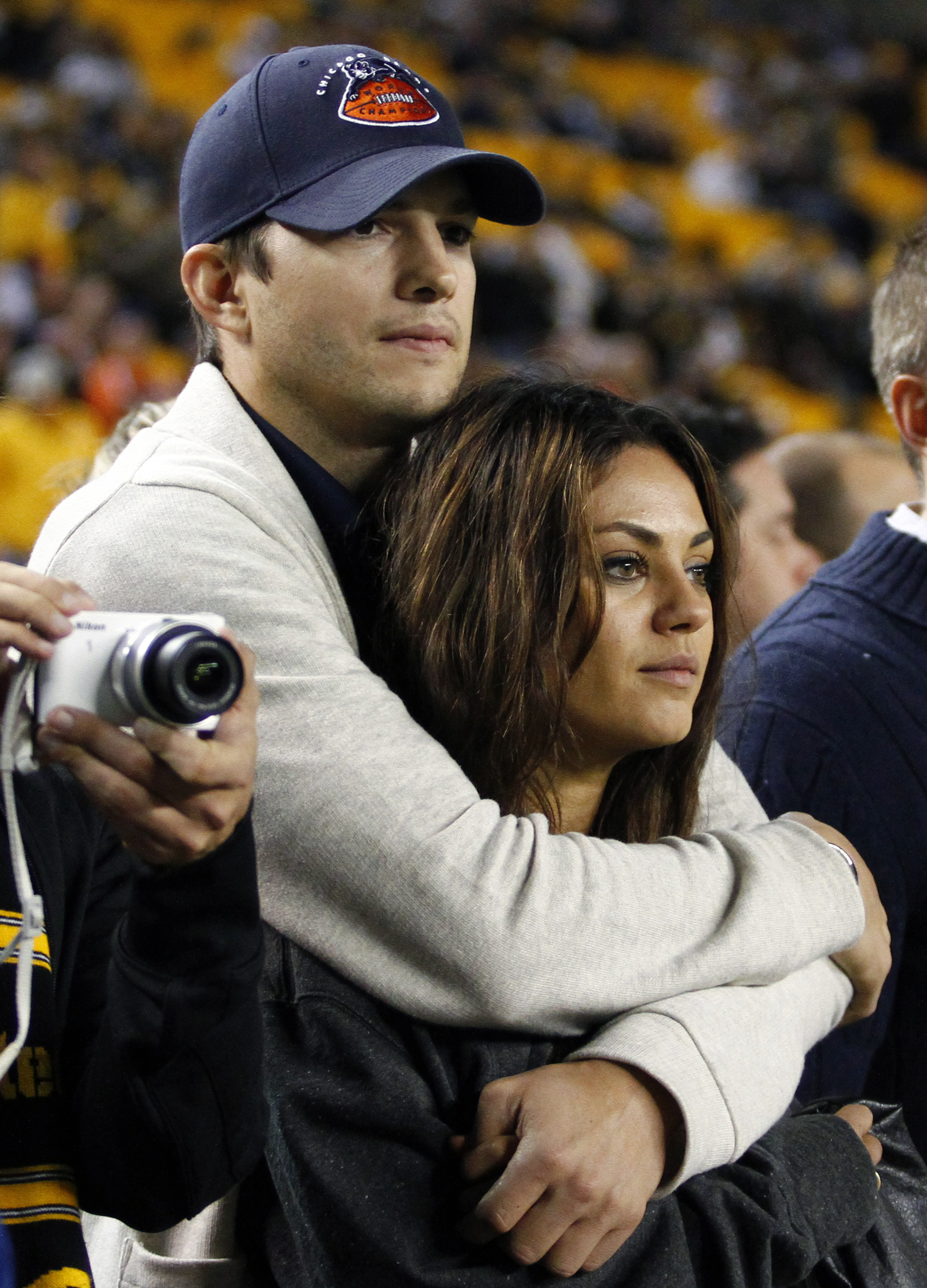 Ashton Kutcher and Mila Kunis look on from the sidelines before the game between the Chicago Bears and the Pittsburgh Steelers on Sept. 22, 2013 at Heinz Field in Pittsburgh.