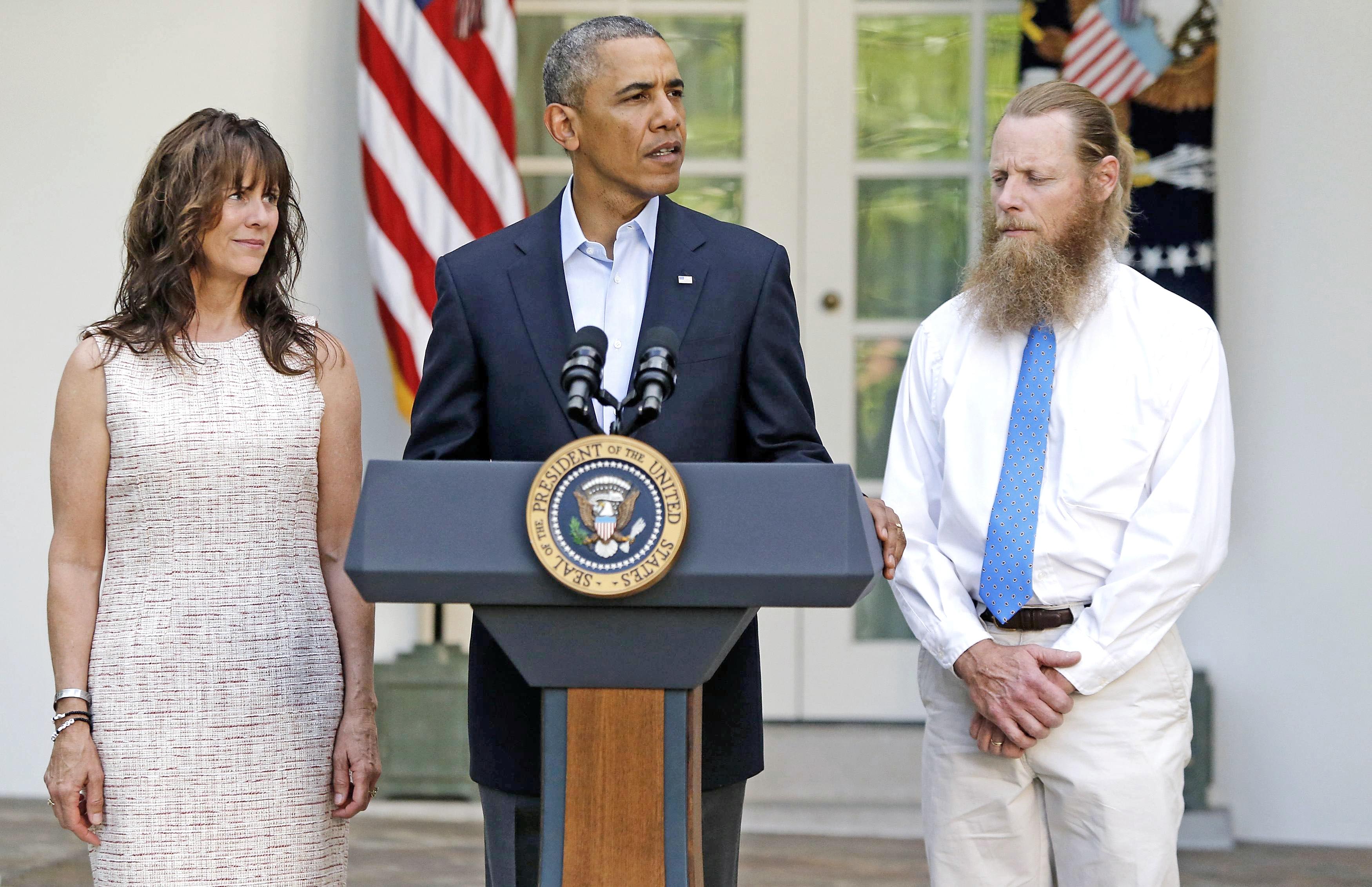 U.S. President Barack Obama stands with Bob Bergdahl (right) and Jami Bergdahl (left) as he delivers a statement about the release of their son, prisoner of war U.S. Army Sergeant Bowe Bergdahl, in the Rose Garden at the White House in Washington, D.C., 