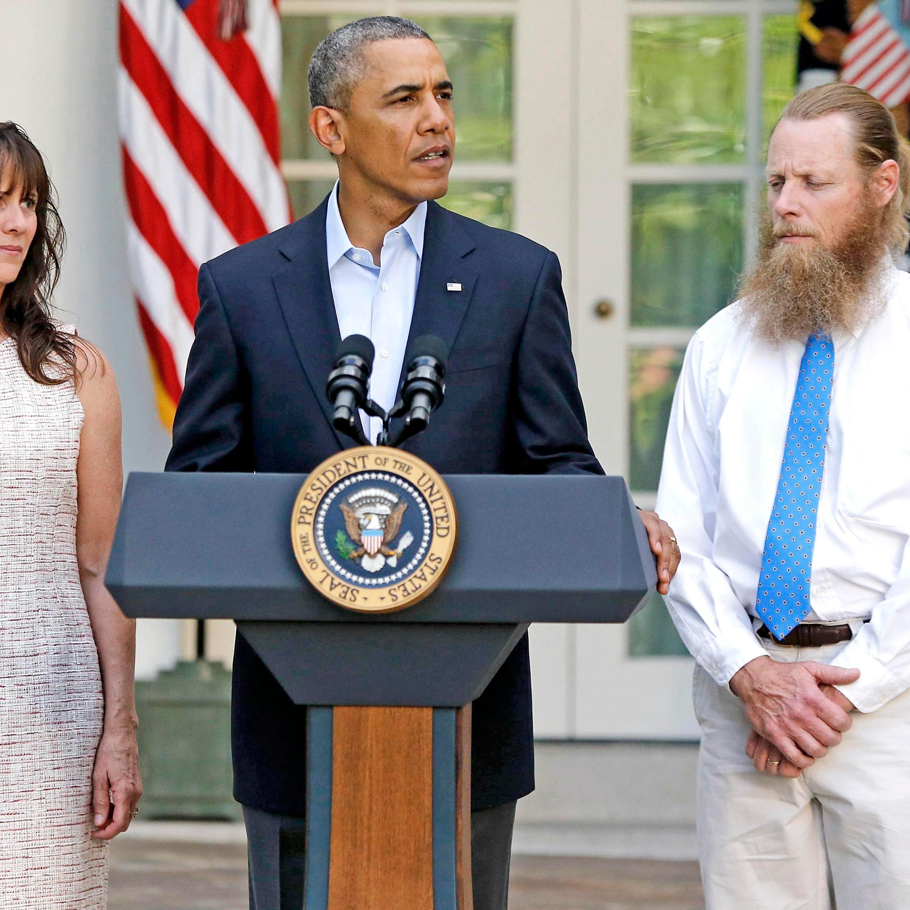 U.S. President Barack Obama stands with Bob Bergdahl (right) and Jami Bergdahl (left) as he delivers a statement about the release of their son, prisoner of war U.S. Army Sergeant Bowe Bergdahl, in the Rose Garden at the White House in Washington, D.C.,