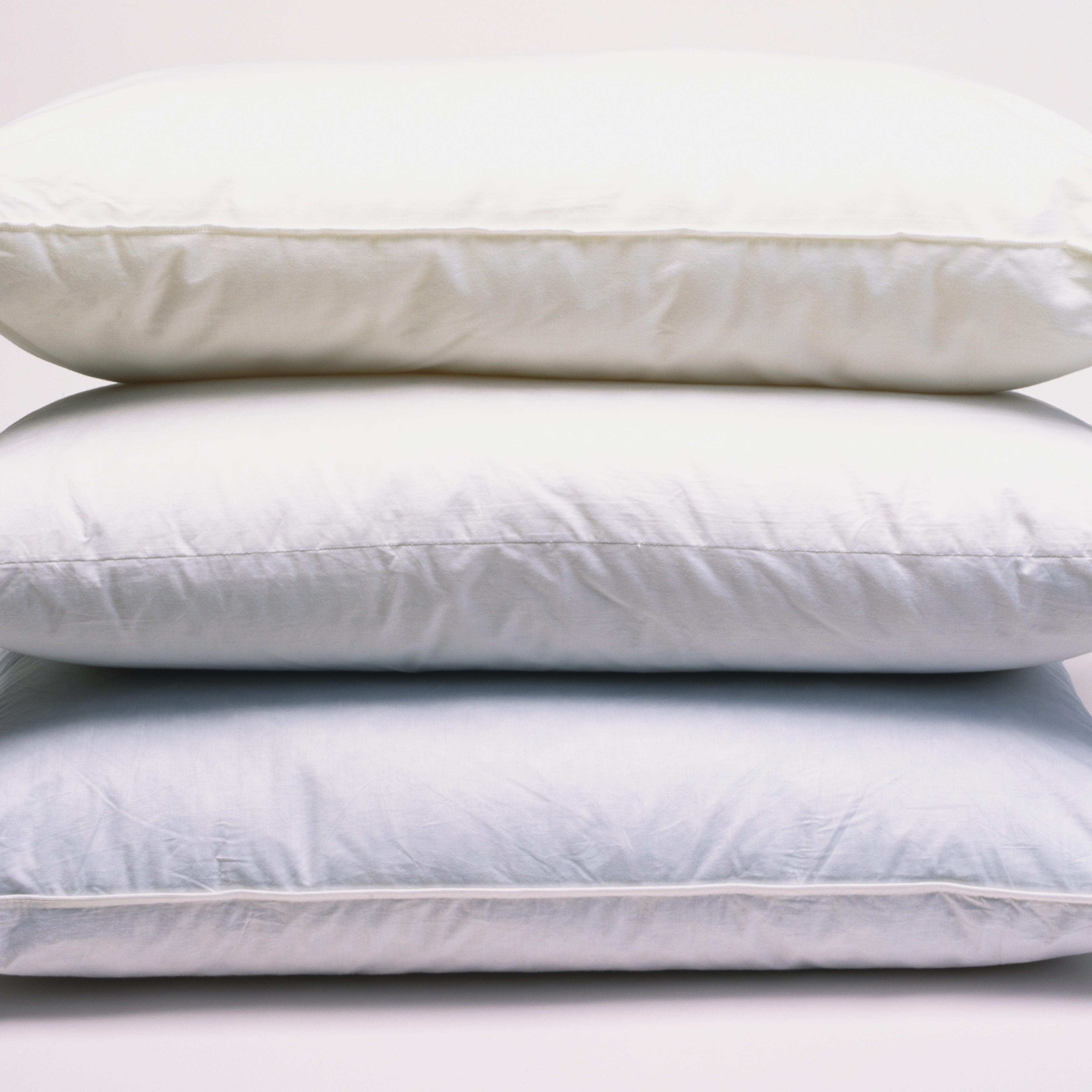 Three stacked white pillows, side view