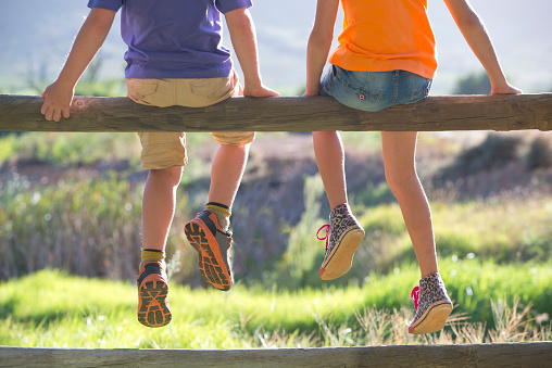 children-sitting-fence
