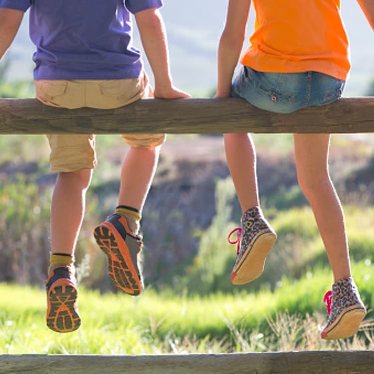 children-sitting-fence