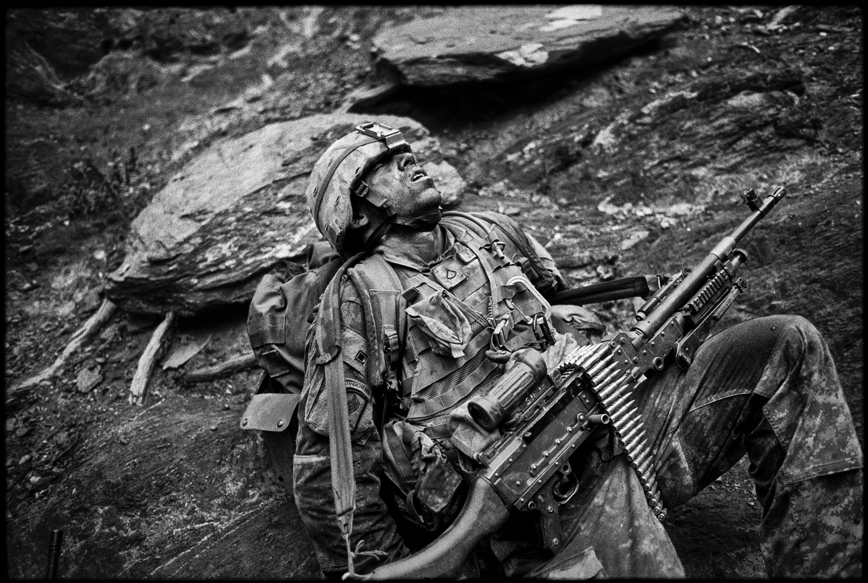 Specialist Sterling Jones of Battle Company in the Second Battalion of the 503rd Infantry Regiment, 173rd Airborne Brigade Combat Team collapses in exhaustion during Operation Rock Avalanche in the Korengal Valley, Afghanistan on October 25, 2007.