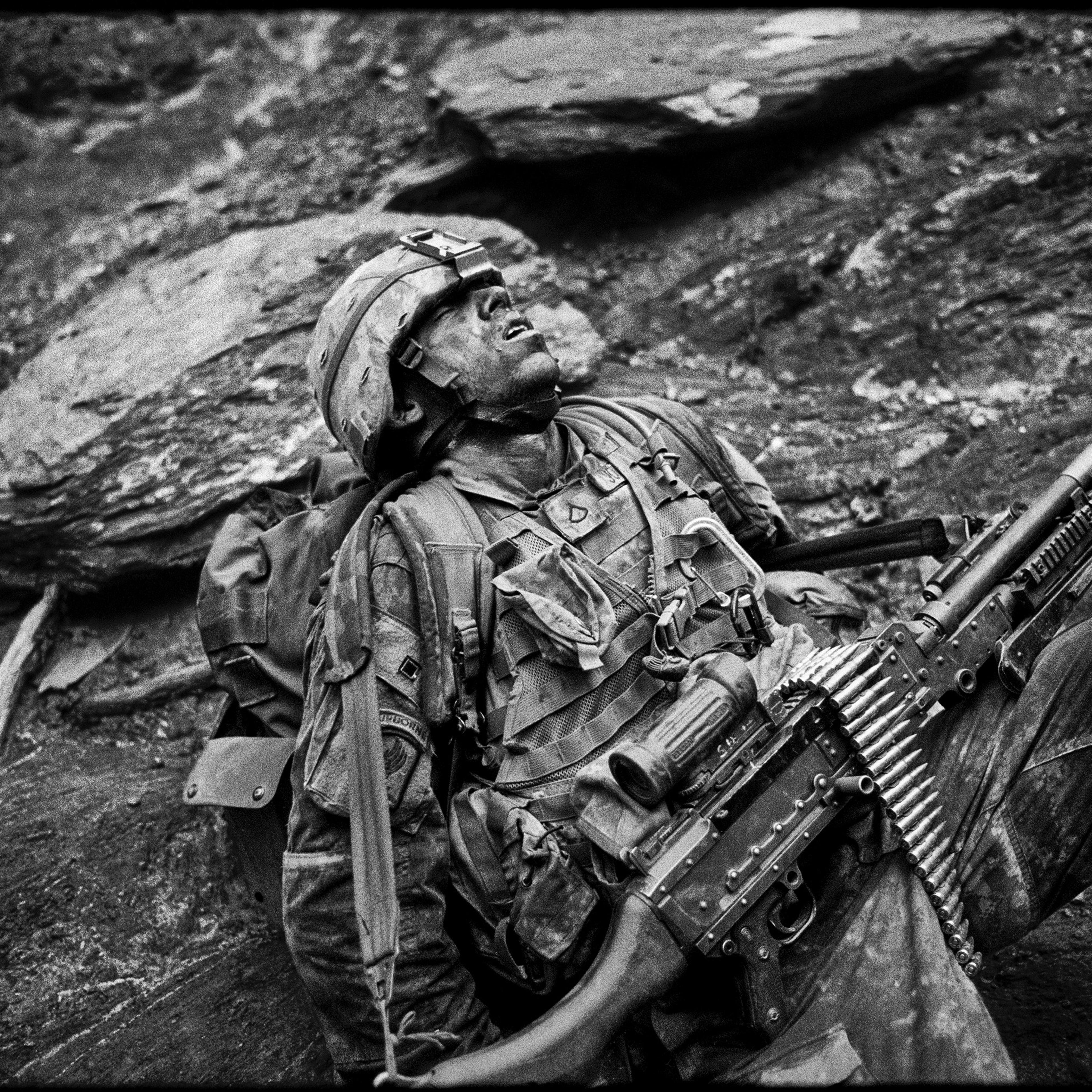 Specialist Sterling Jones of Battle Company in the Second Battalion of the 503rd Infantry Regiment, 173rd Airborne Brigade Combat Team collapses in exhaustion during Operation Rock Avalanche in the Korengal Valley, Afghanistan on October 25, 2007.