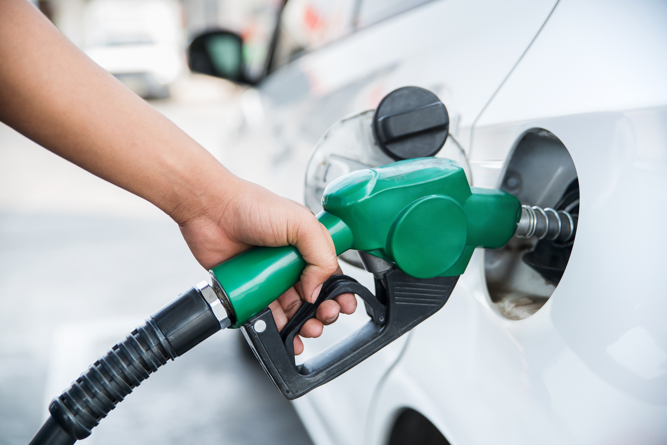 Handle fuel nozzle to refuel the car.