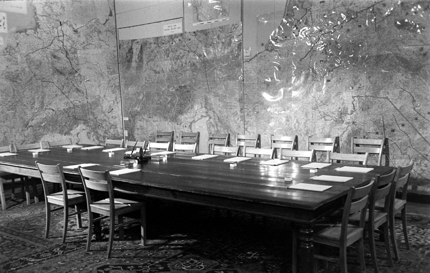 The surrender room was SHAEF War Room, lined with operational maps, tables of casualties, supplies, Army strengths, prisoners. Pads, pencils and name plates were at each place.