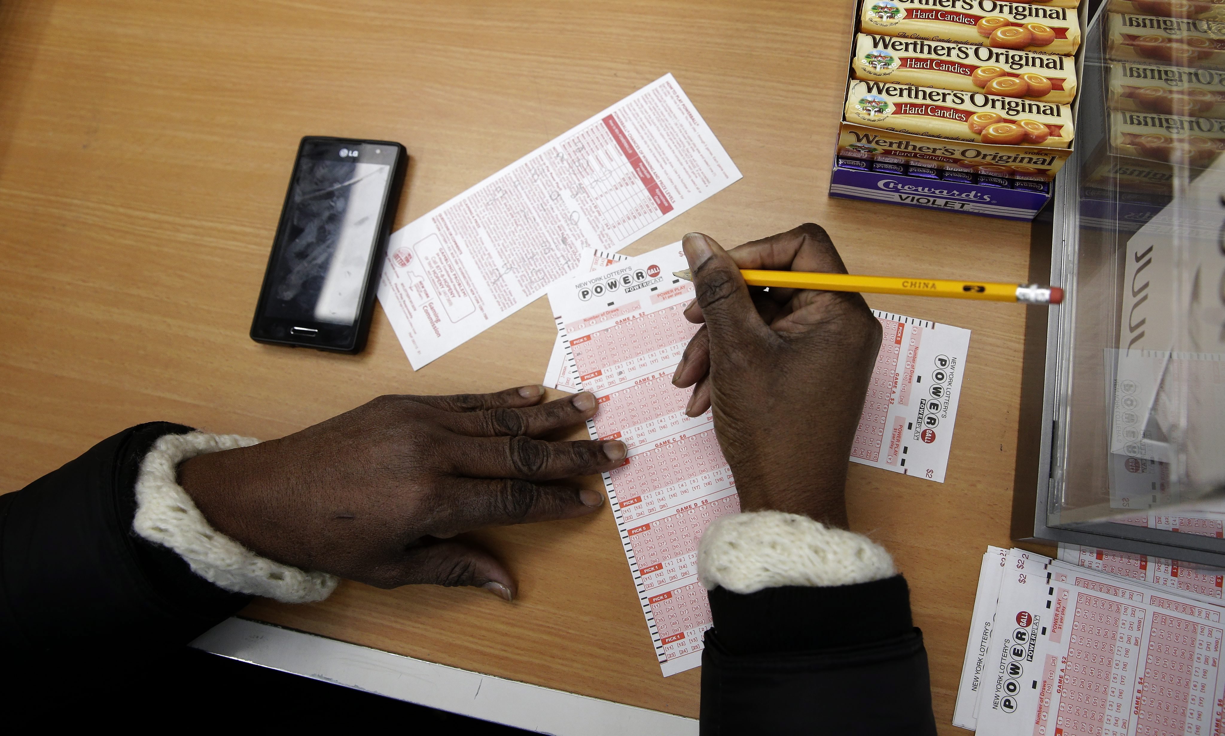 A woman fills out a ticket for the multi-state Powerball lottery jackpot in Brooklyn, New York on Jan. 13, 2016.