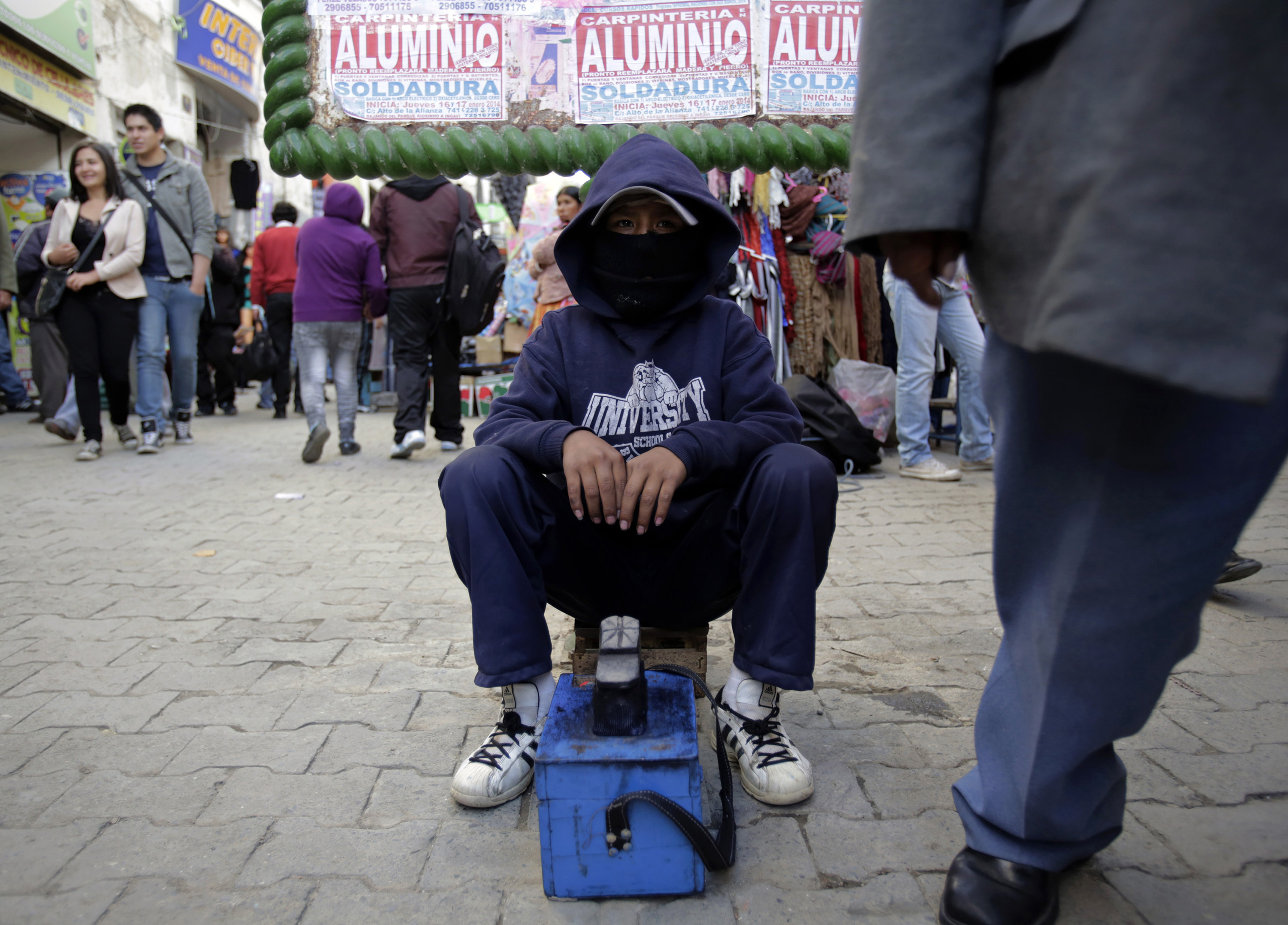 A boy works as a shoe shiner in La Paz, Bolivia, Jan. 8, 2014.