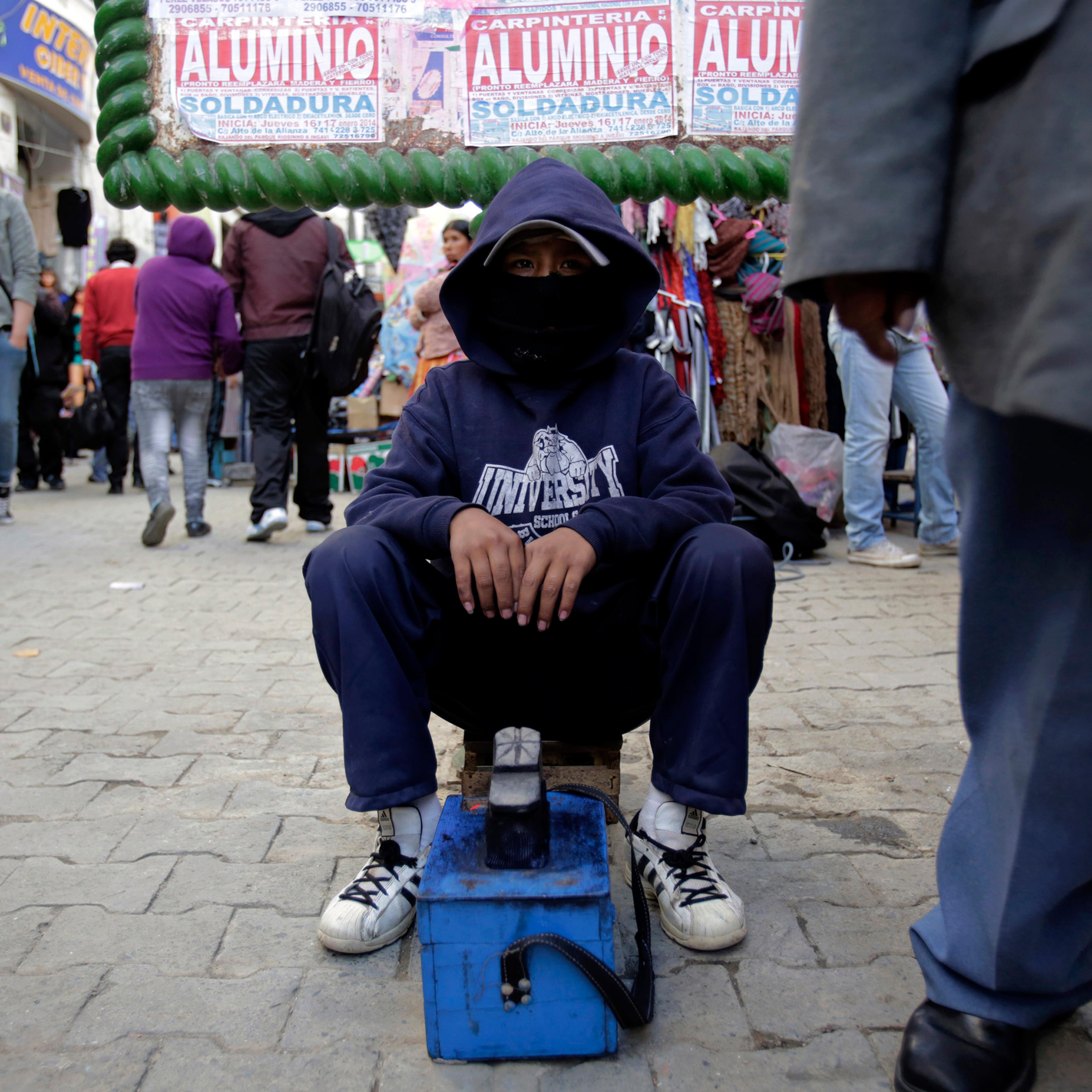 A boy works as a shoe shiner in La Paz, Bolivia, Jan. 8, 2014.