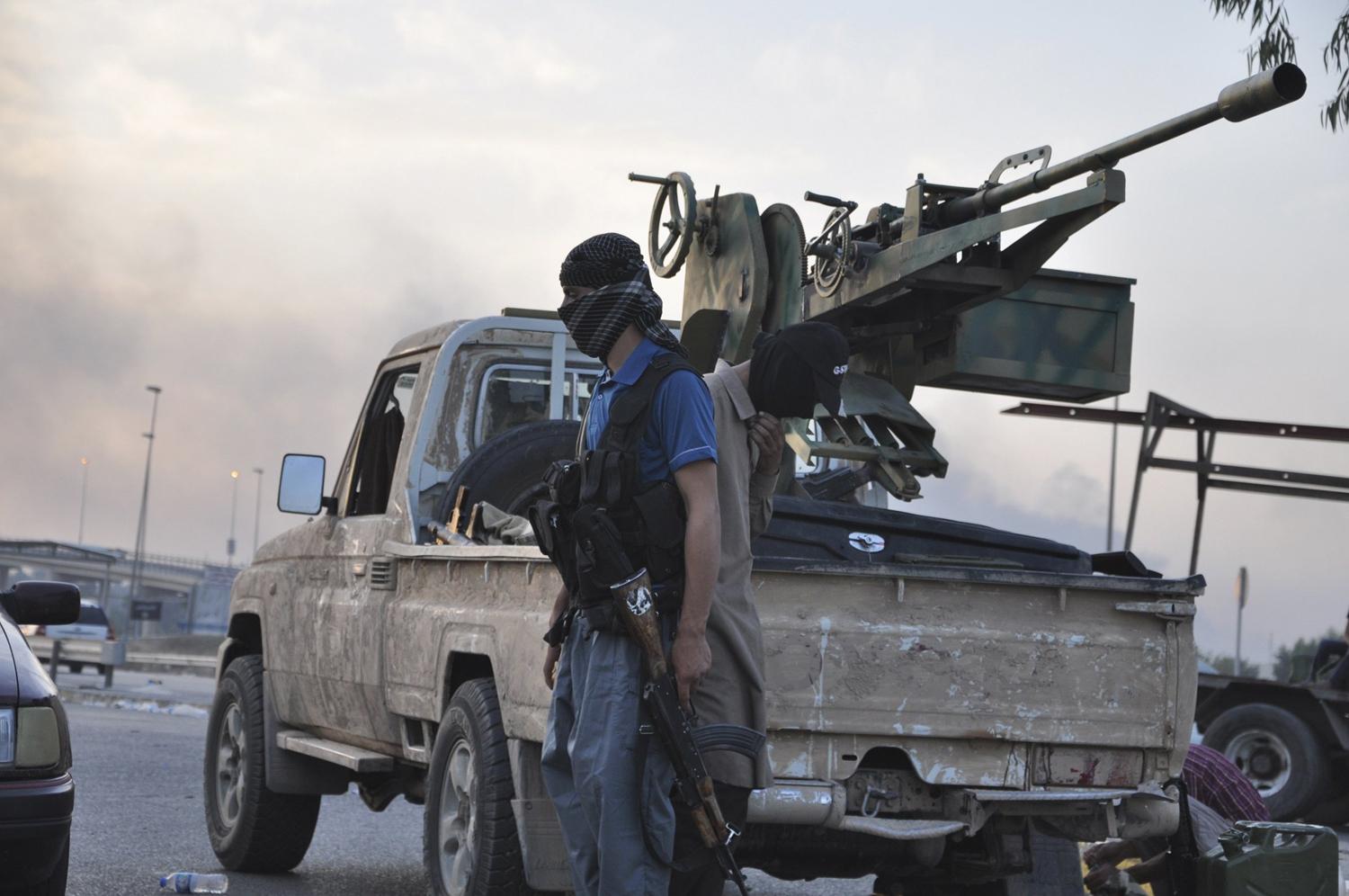 Fighters of the Islamic State of Iraq and Greater Syria stand guard at a checkpoint in the northern Iraq city of Mosul, June 11, 2014.