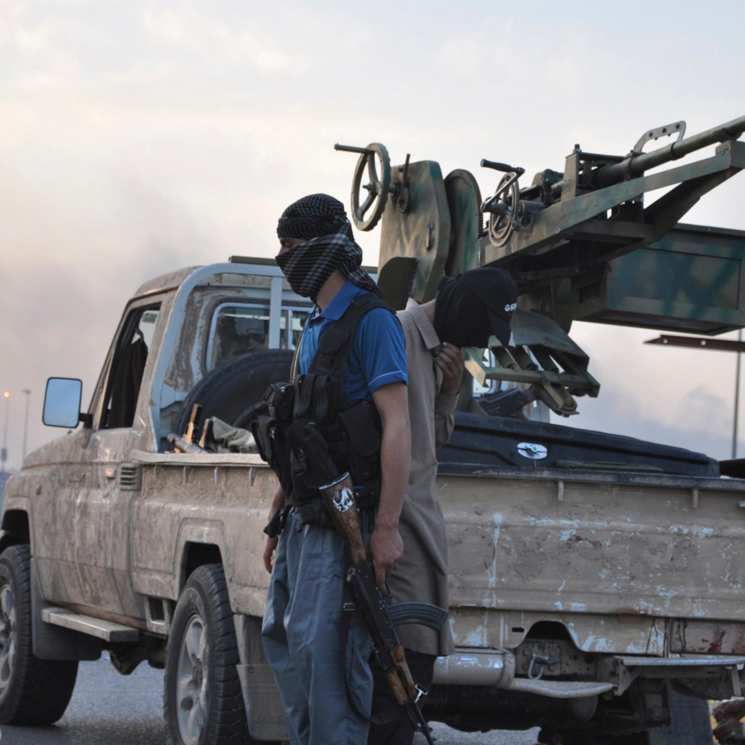 Fighters of the Islamic State of Iraq and Greater Syria stand guard at a checkpoint in the northern Iraq city of Mosul, June 11, 2014.