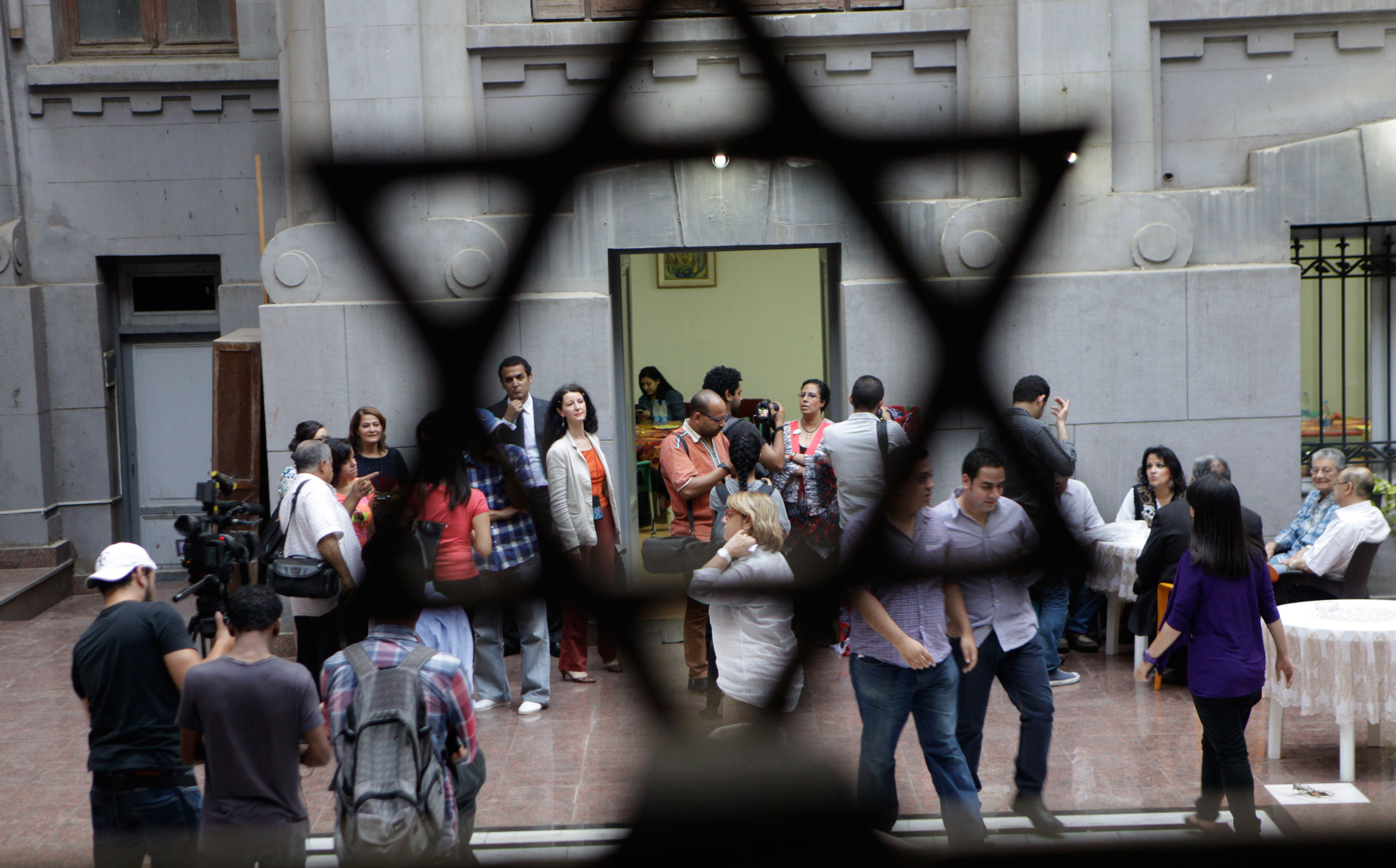 Egyptians gather inside Shaar Hashamayim synagogue as they wait to break their fast in Cairo, Egypt, Wednesday, July 9, 2014. The Jewish community in Egypt hosted for the first time an Iftar party, evening meal when Muslims break their fast during the Is