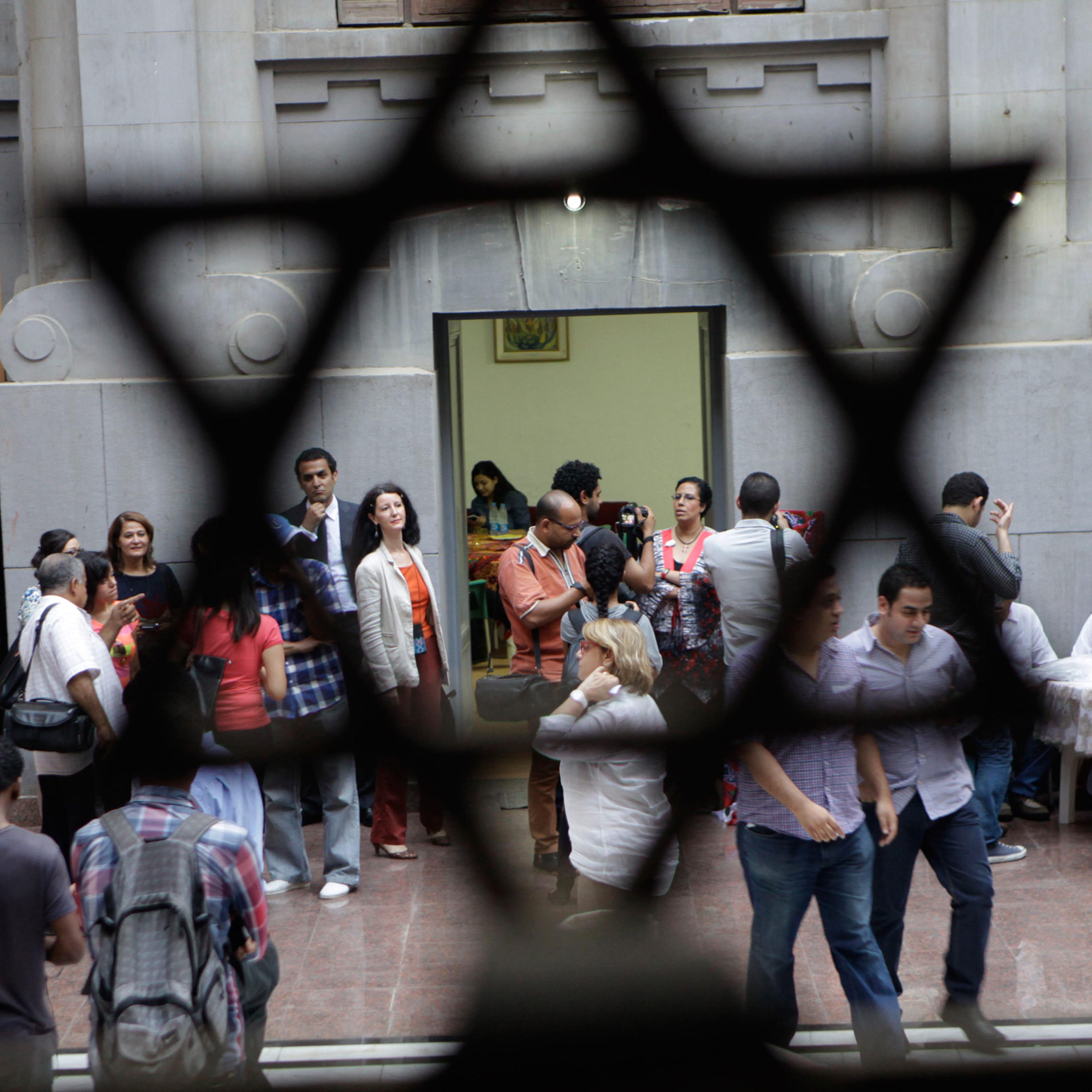 Egyptians gather inside Shaar Hashamayim synagogue as they wait to break their fast in Cairo, Egypt, Wednesday, July 9, 2014. The Jewish community in Egypt hosted for the first time an Iftar party, evening meal when Muslims break their fast during the Is