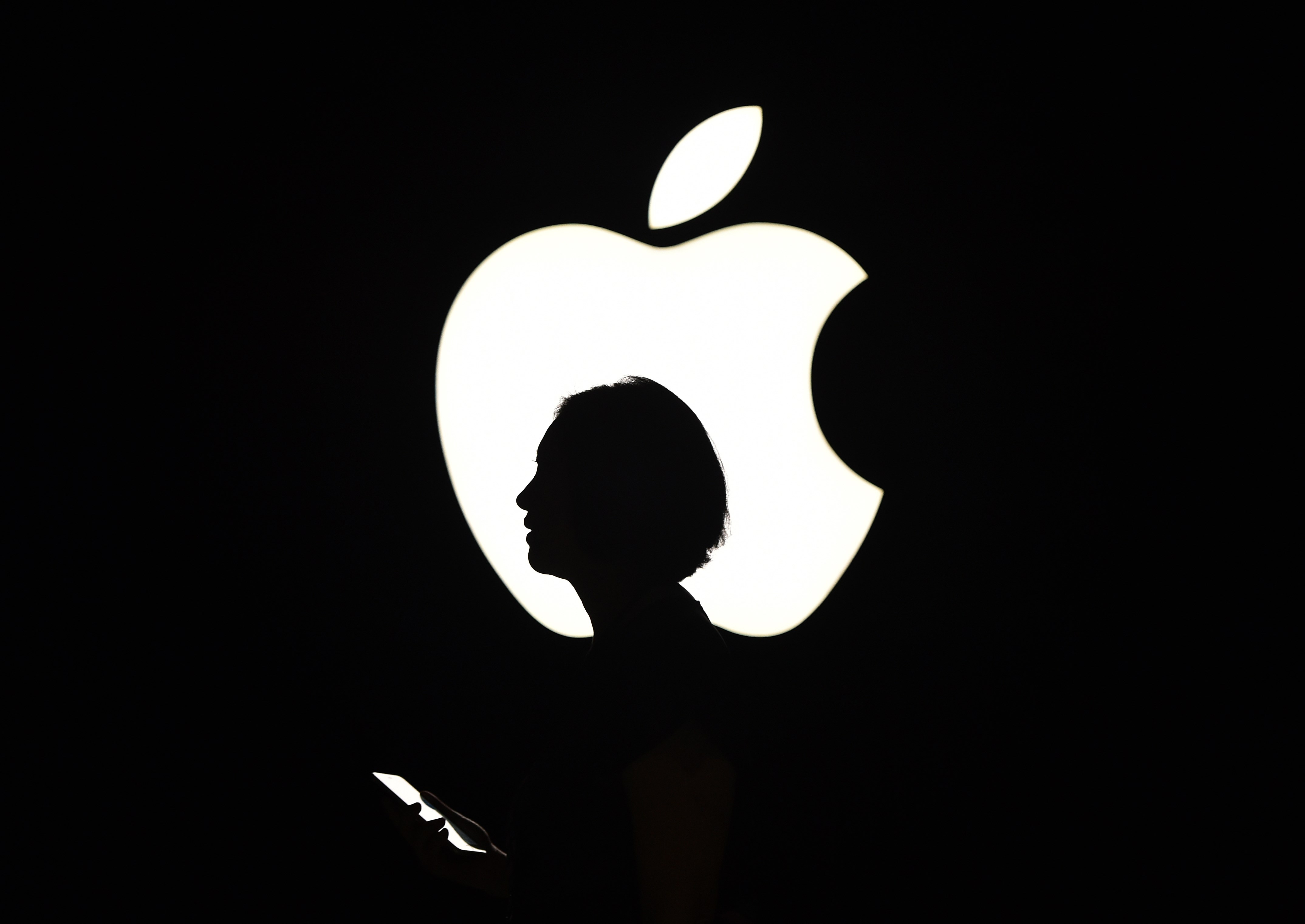 A reporter walks by during an Apple event in San Francisco on Sept. 9, 2015.