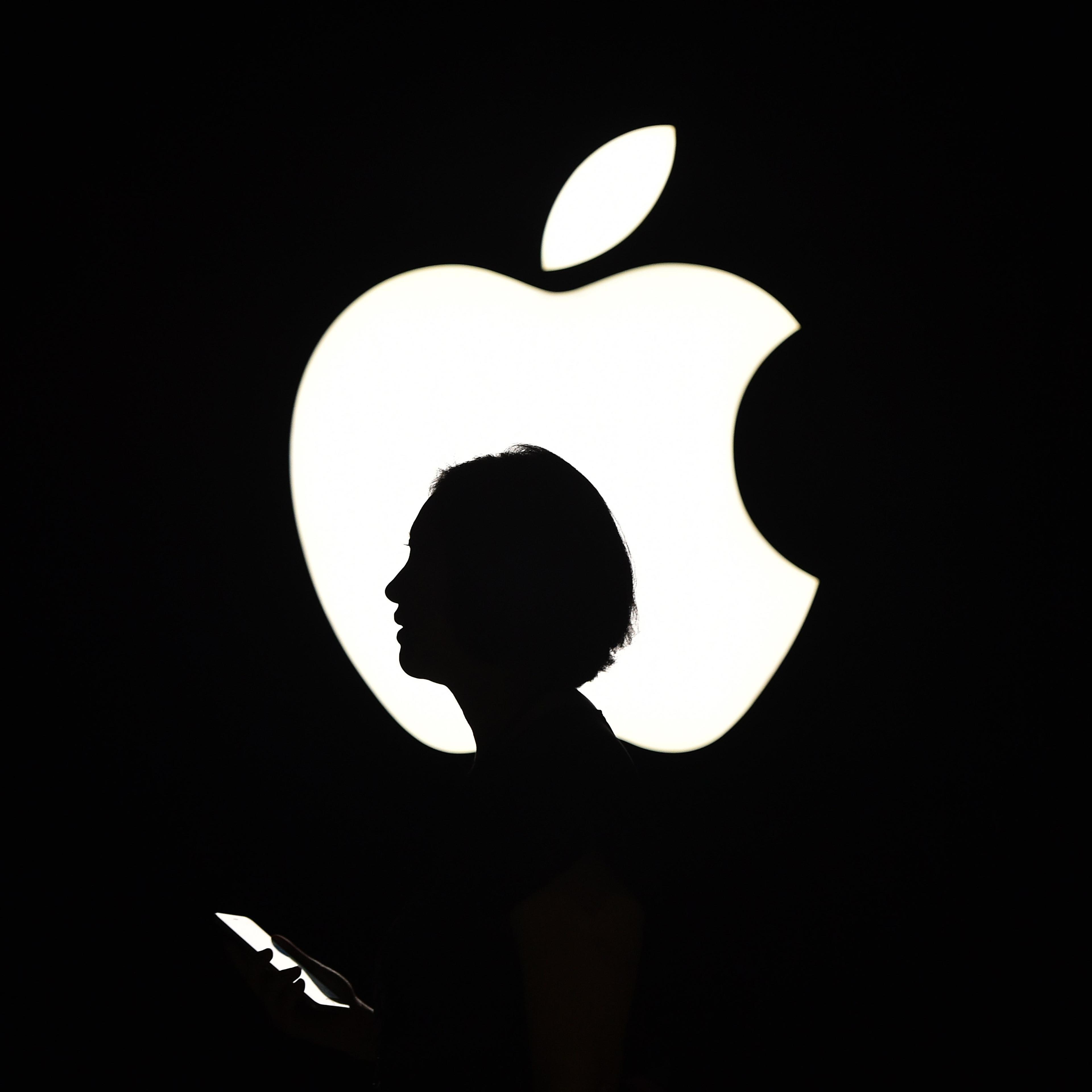 A reporter walks by during an Apple event in San Francisco on Sept. 9, 2015.