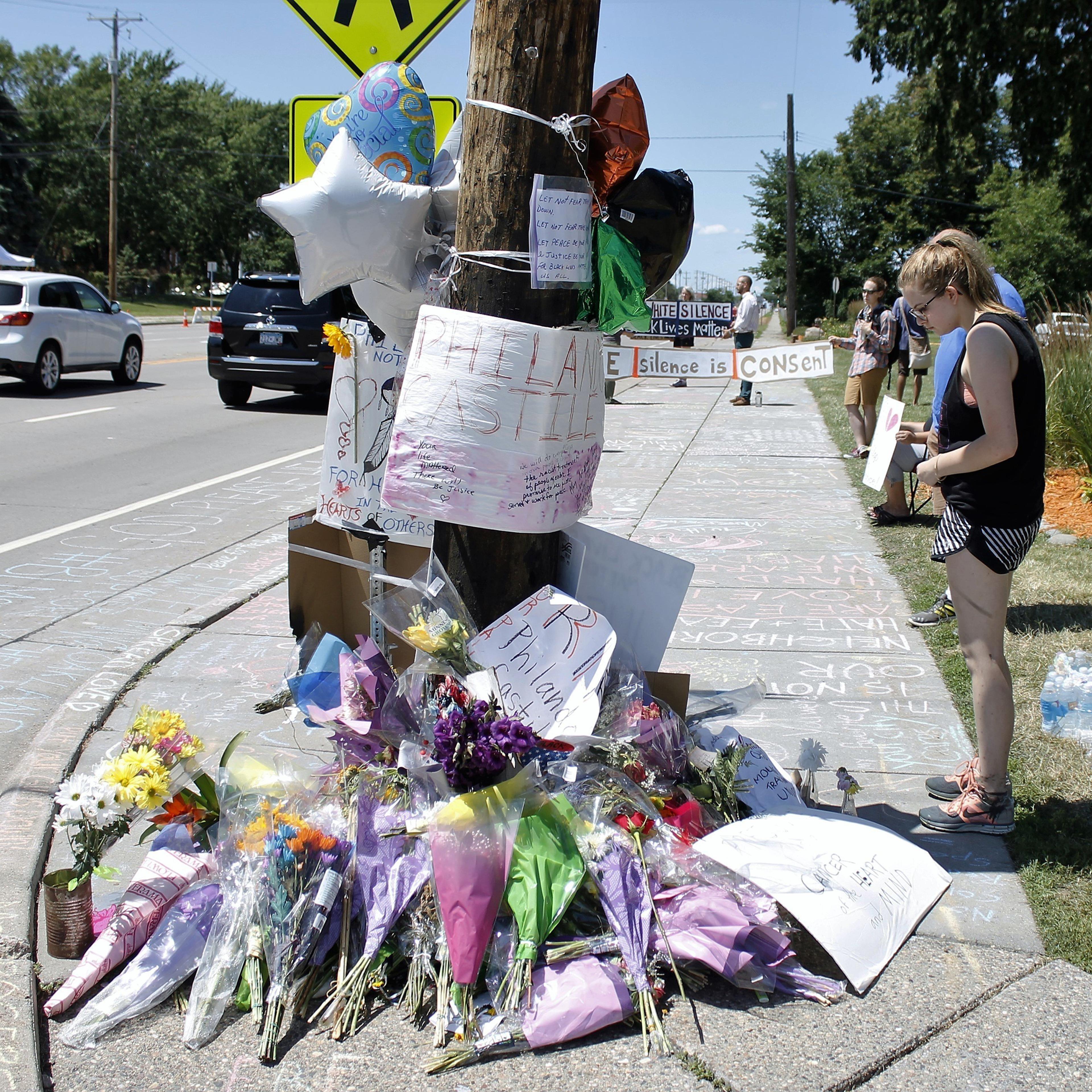 A person looks at a memorial in the Minneapolis suburb of Falcon Heights near the spot where Philando Castile was shot and killed by a police officer, July 9, 2016,.