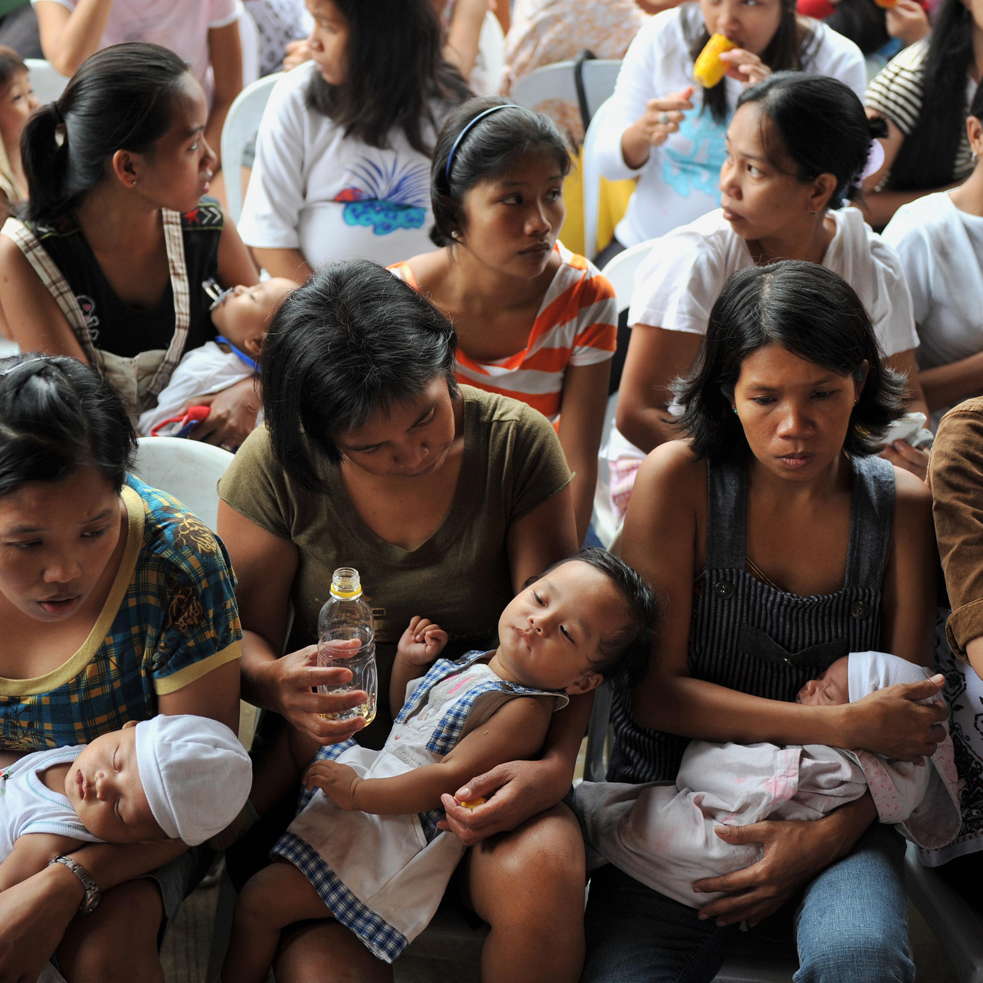 TO GO WITH Philippines-flood-baby,FOCUS