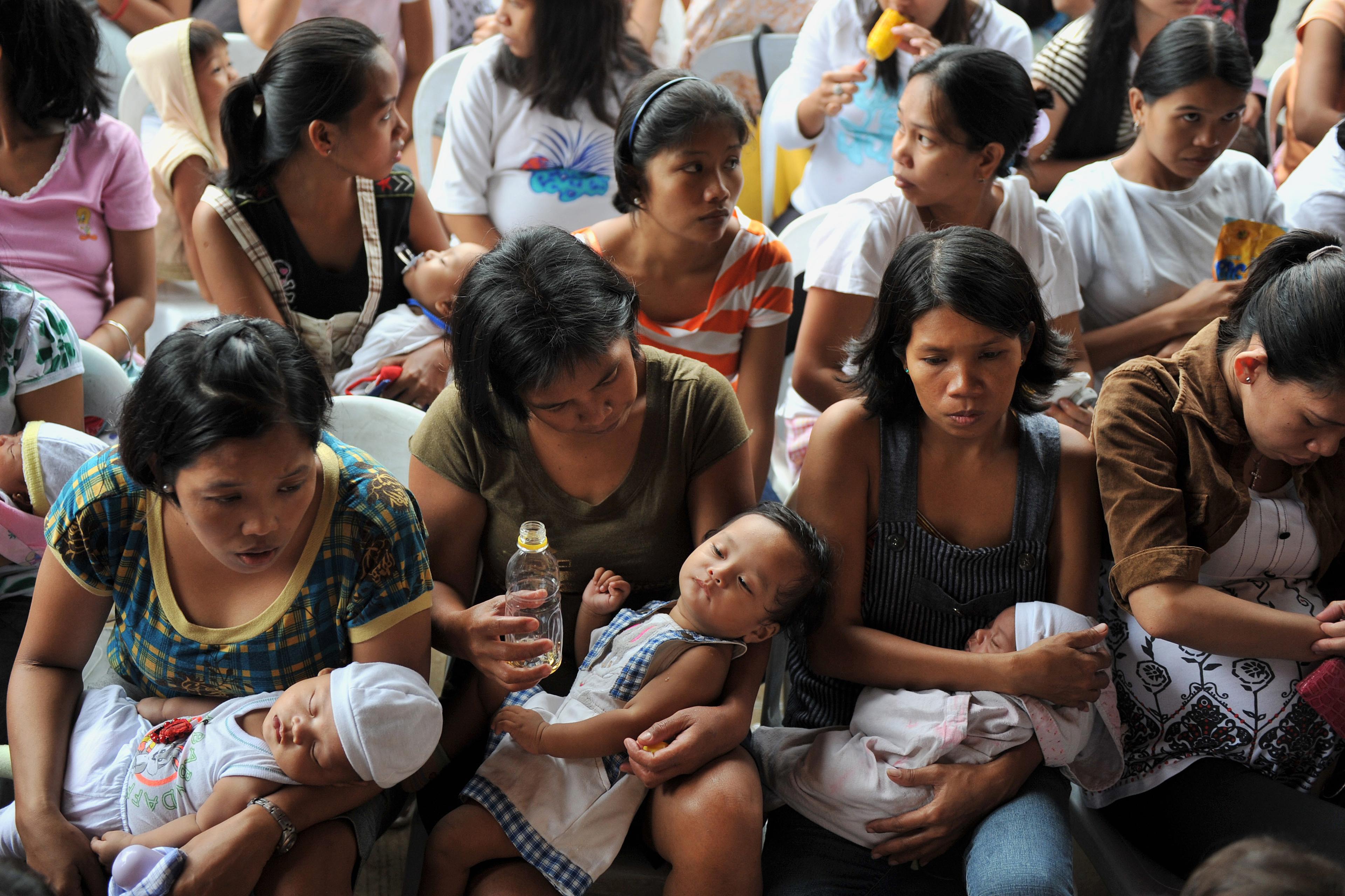 TO GO WITH Philippines-flood-baby,FOCUS