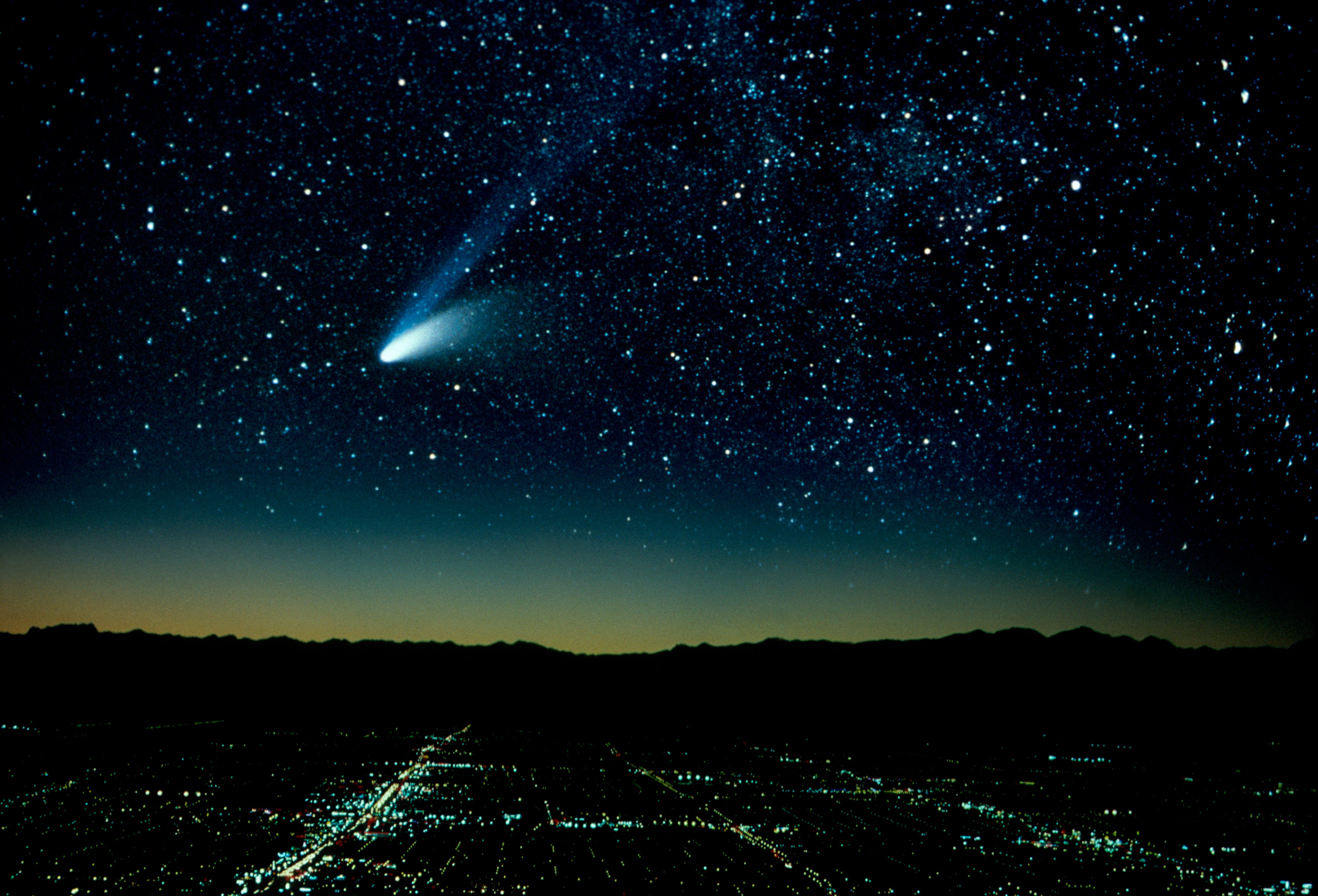 Hale-Bopp Comet And City At Night